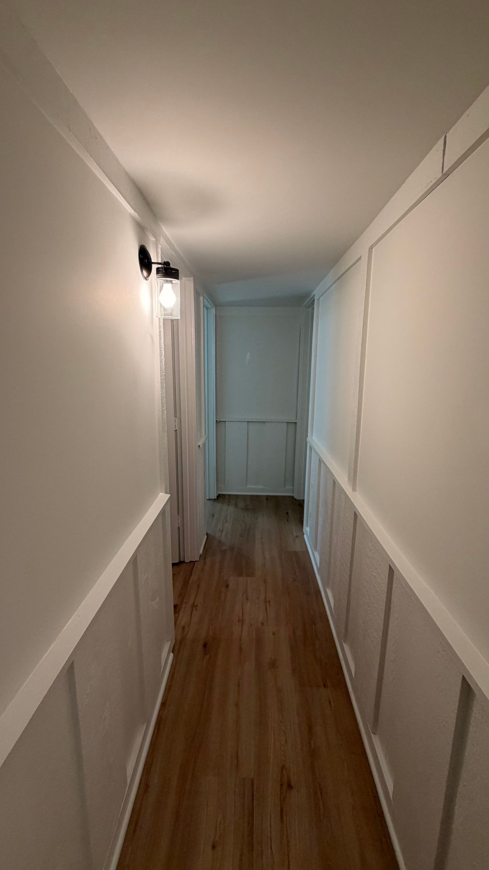 Basement Remodeling with Wood-Look Flooring and Custom Wainscoting in Dunwoody by Swift Home Renovations