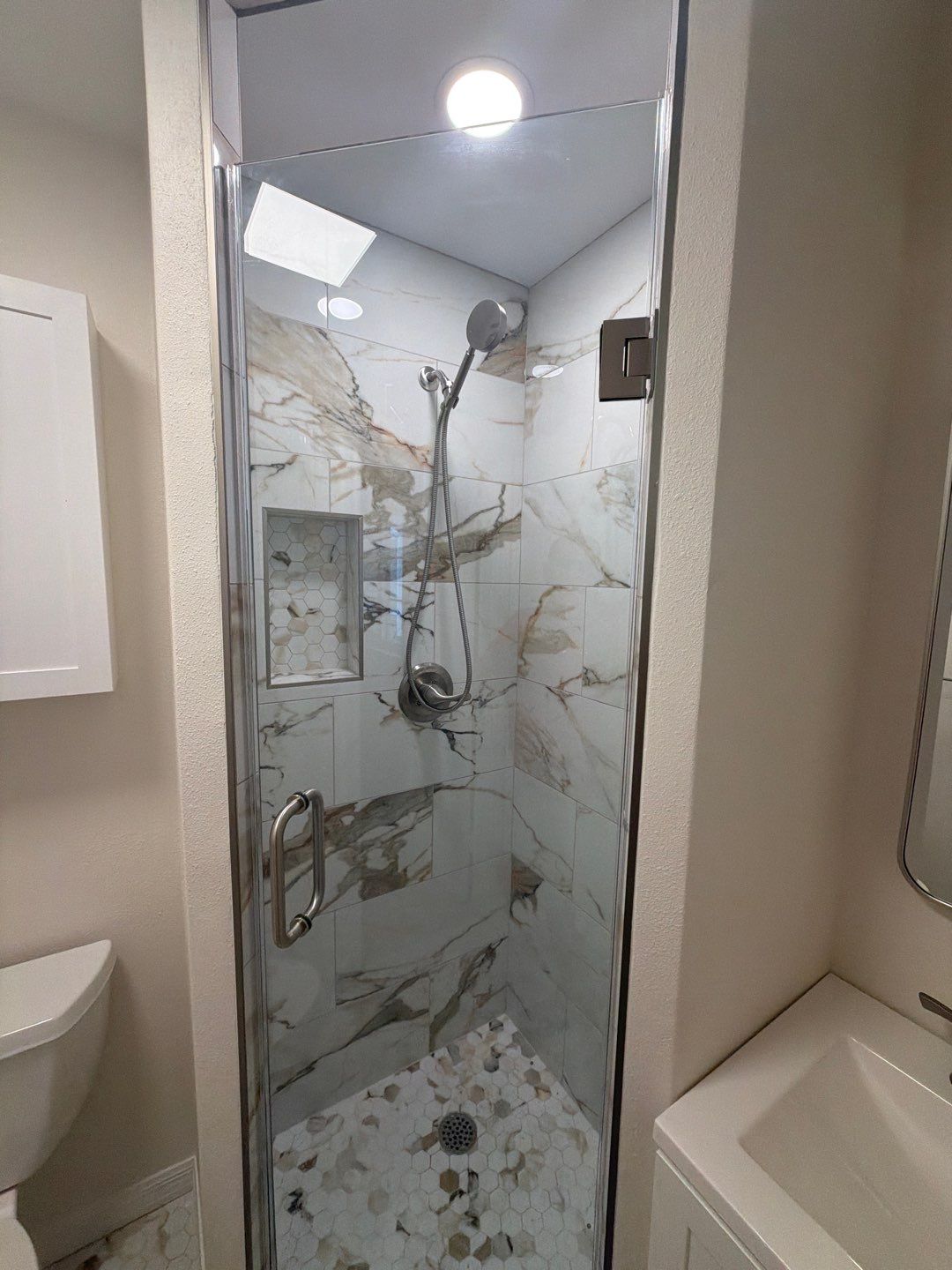 Modern Bathroom Remodel Featuring Marble Tile in Ormond Beach by Acies Renovations
