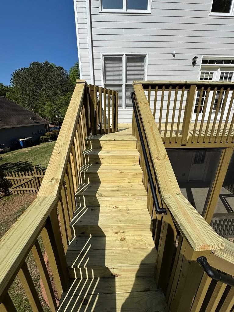 Kennesaw Deck Renovation Featuring Pressure-Treated Lumber and Metal Railings by Swift Home Renovations