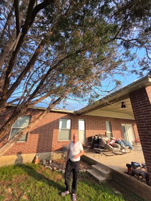 Standing seam metal roof on home with person standing outside.