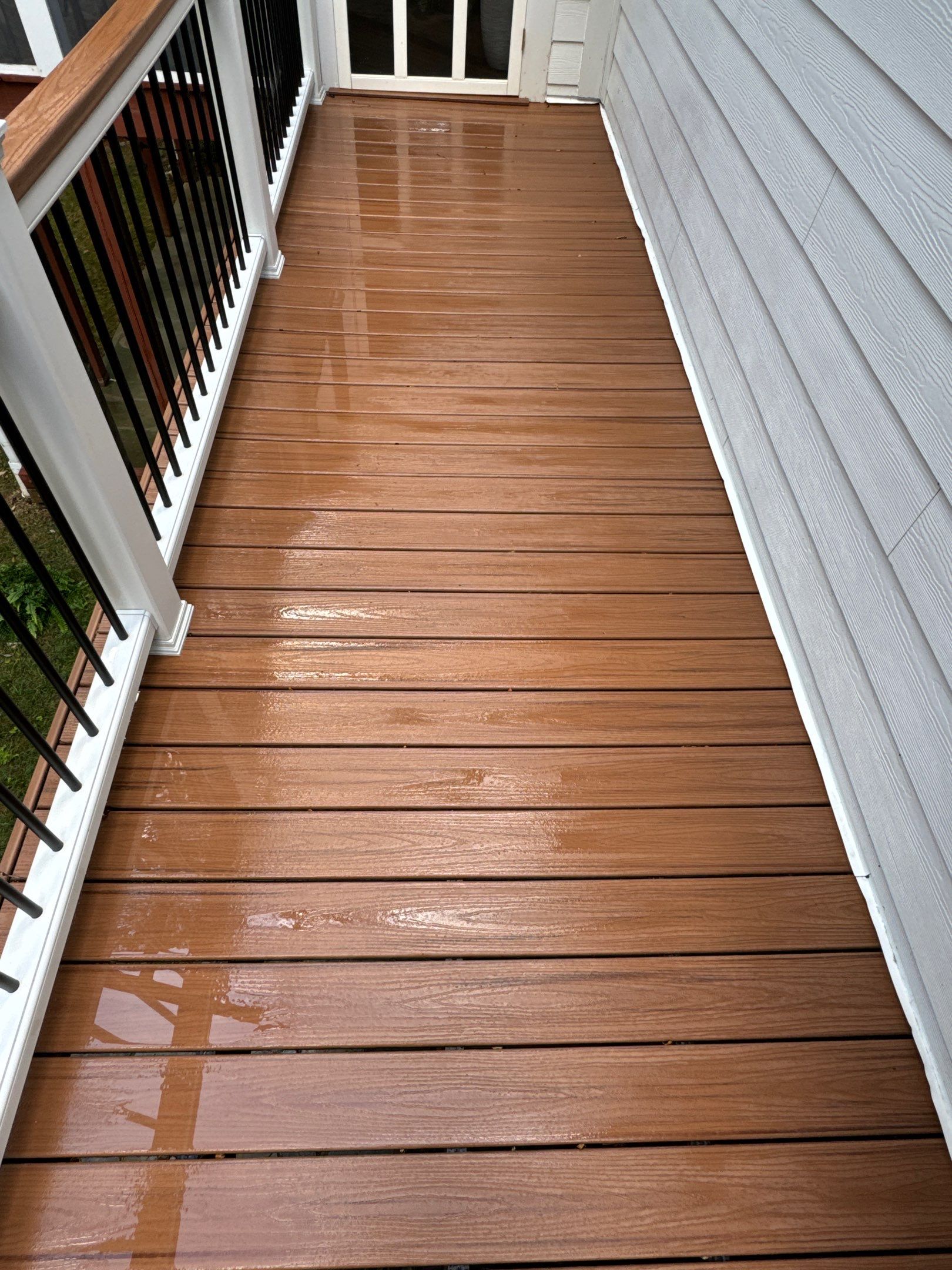 pressure washing company cleaning deck boards and house siding