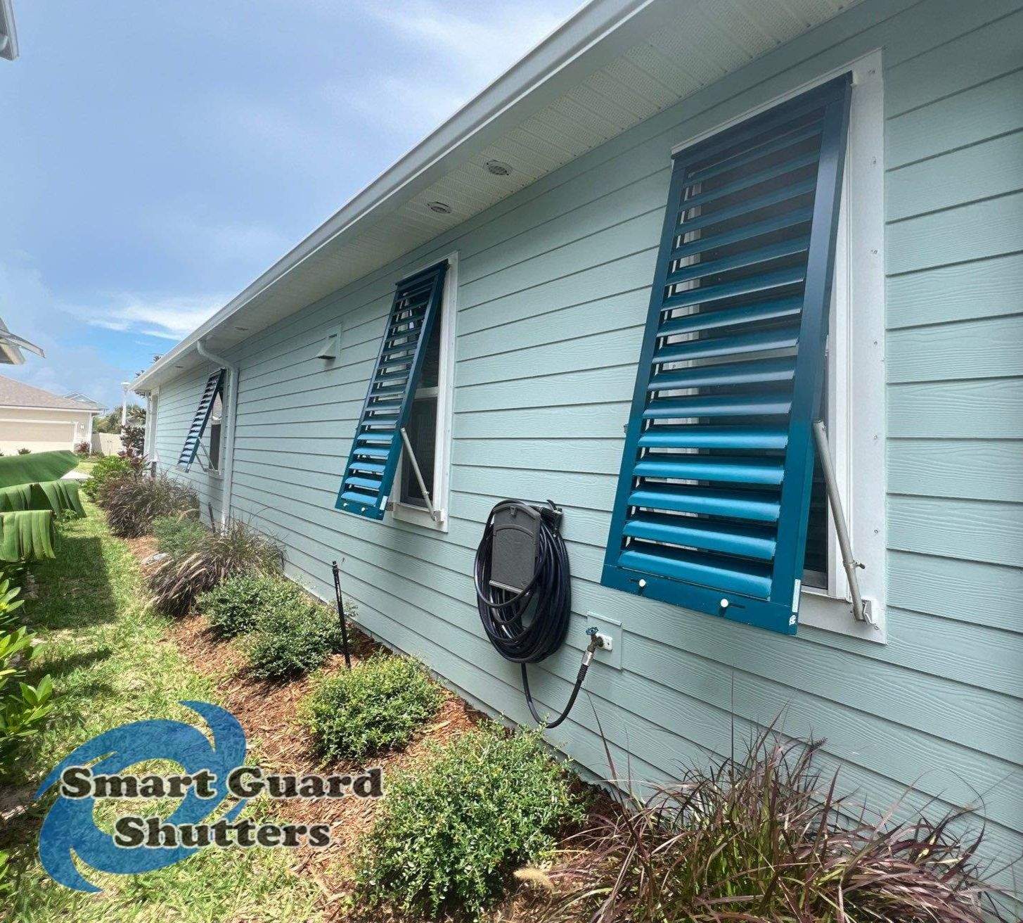 Impact Bahama Shutters in Ocean Blue by Smart Guard Shutters