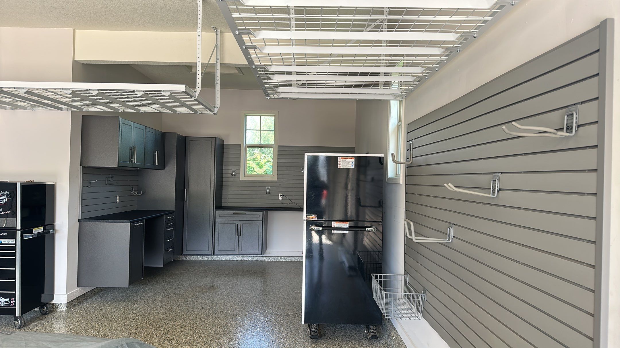 Lori H. upgrade her garage with cabinets and overhead racks by Banner Garage