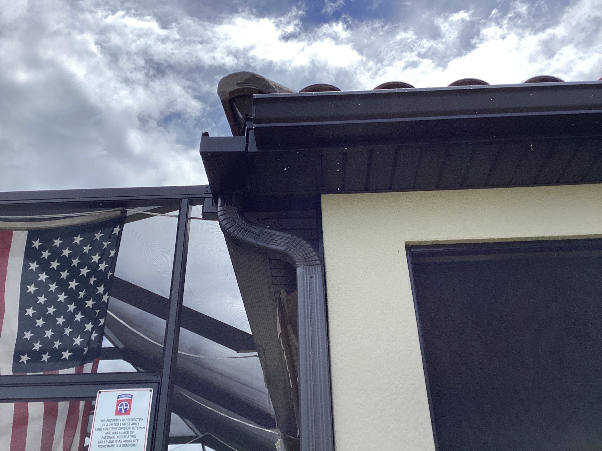 Musket brown seamless gutters with splash guards, new downspouts, and extensions in Bradenton, FL by Gutter Professors