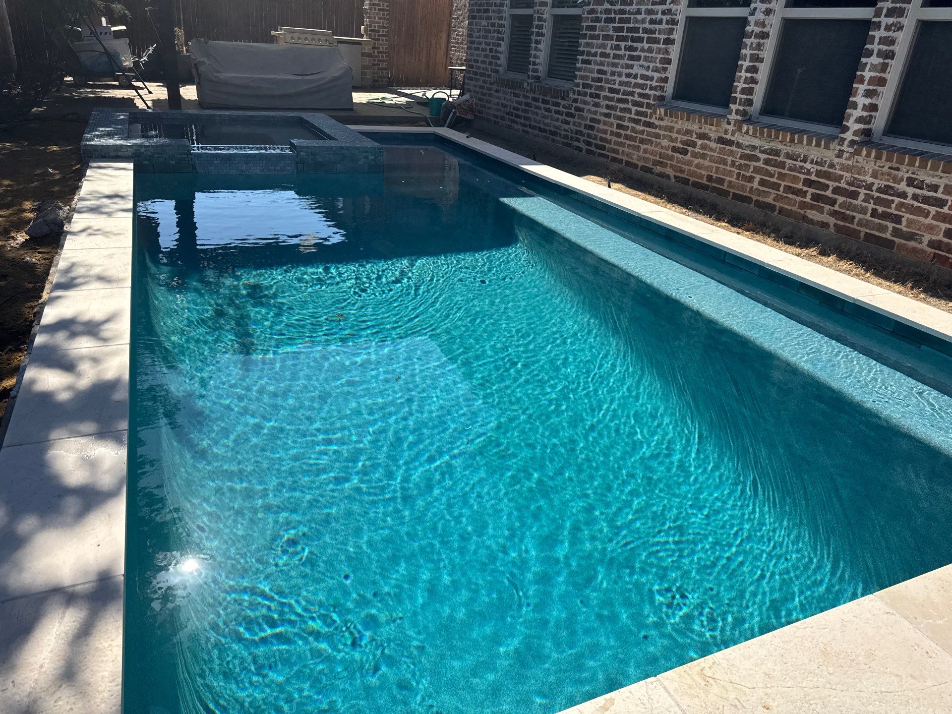 Geometric Pool with Raised Stone Spa by Pinnacle Pools and Spas - DFW
