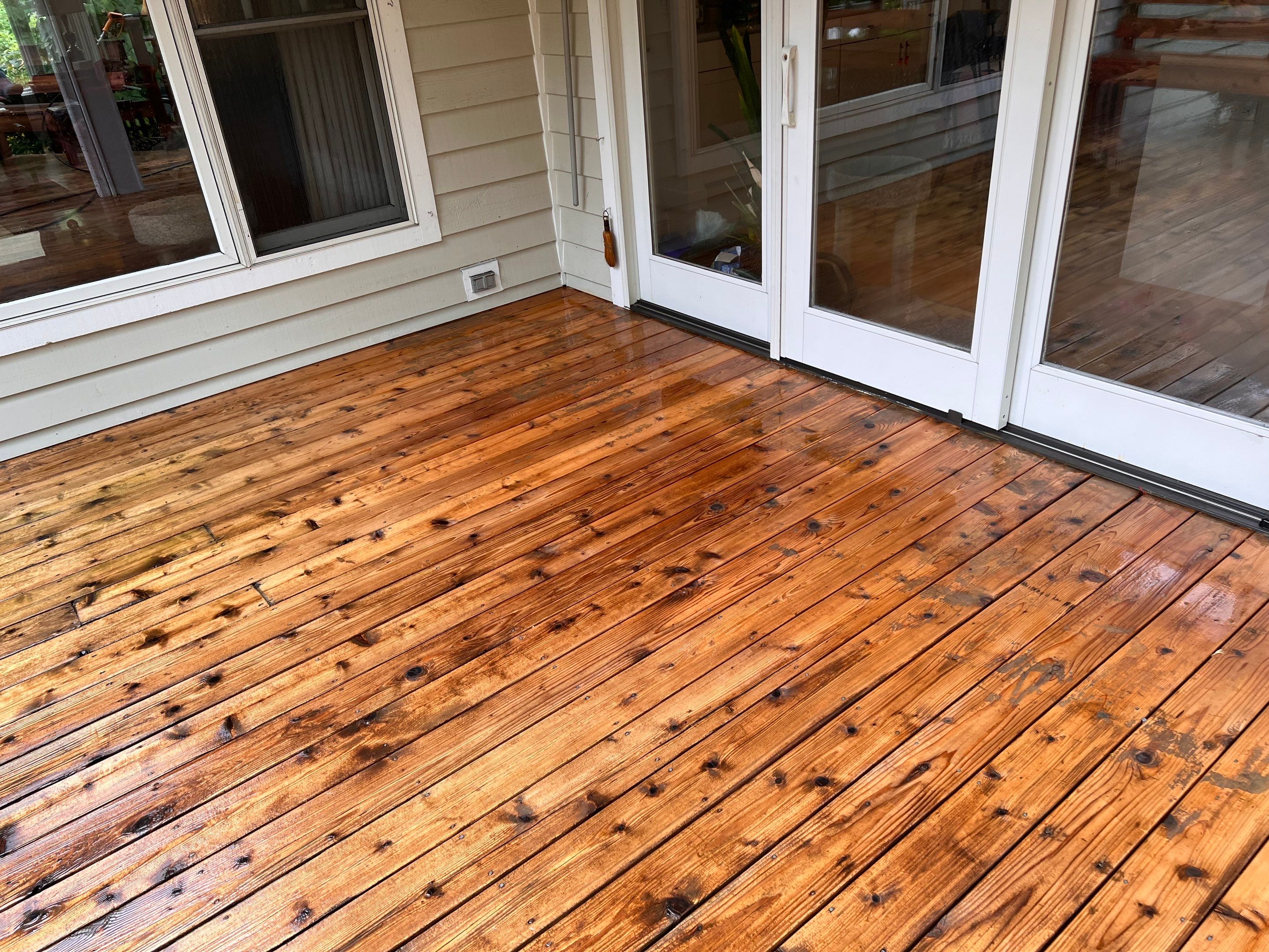 Wood deck cleaning, board replacement and staining by Northern Power Washing LLC.