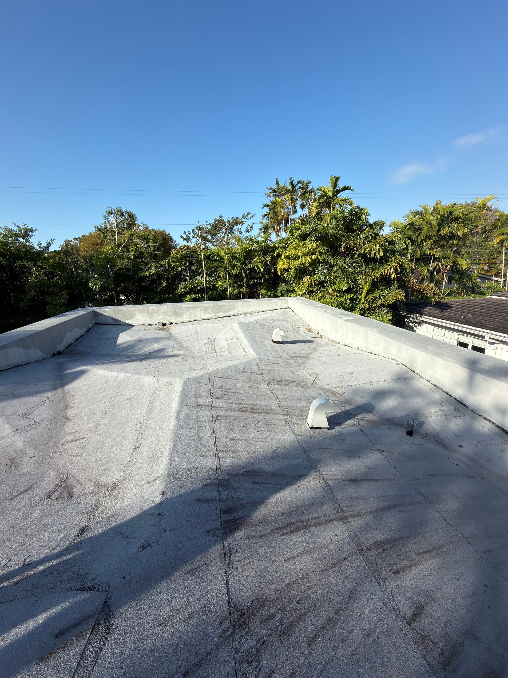 Flat Roof Silicone Coating and Interior Water Damage Restoration in Miami by Picos Construction Engineering