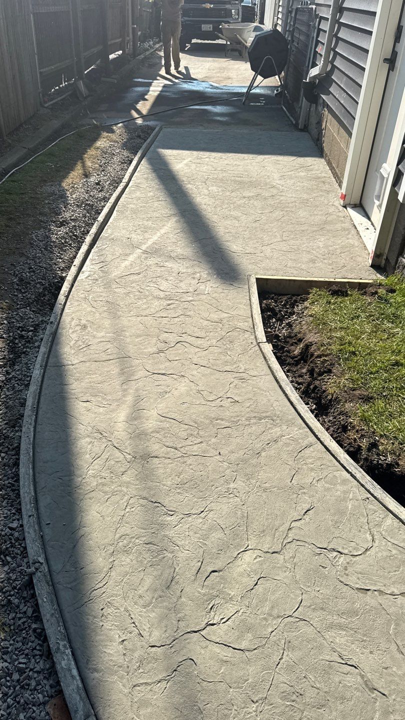 Oxford slate stamped patio and walkway  by NG Masonry & Construction LLC