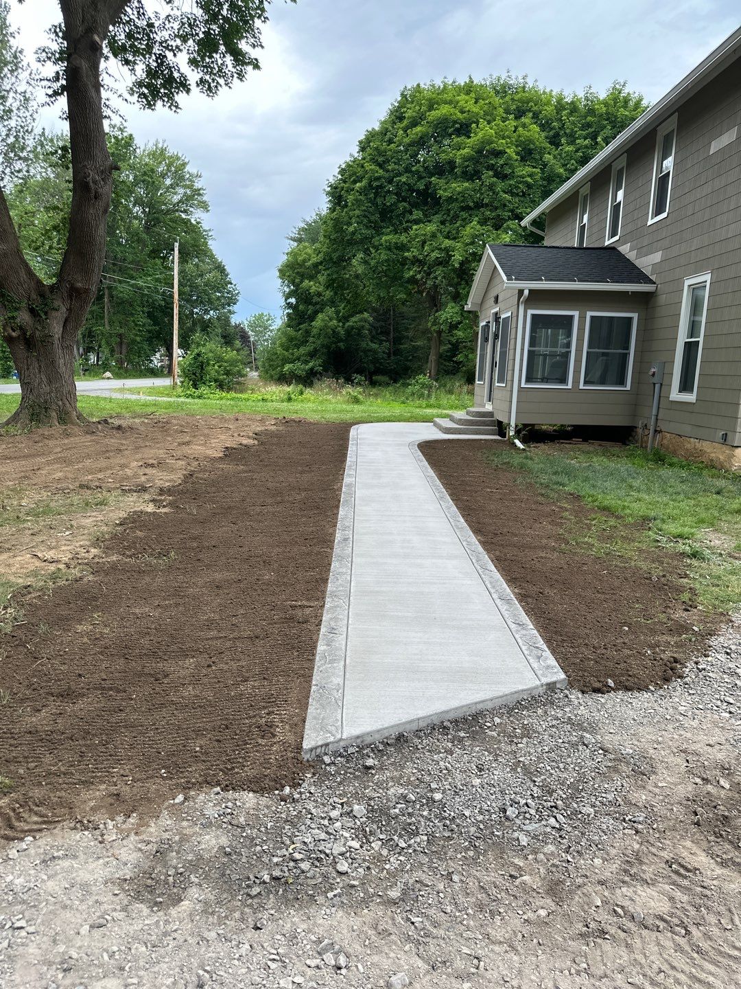 Broom finished concrete patio and sidewalk  by NG Masonry & Construction LLC
