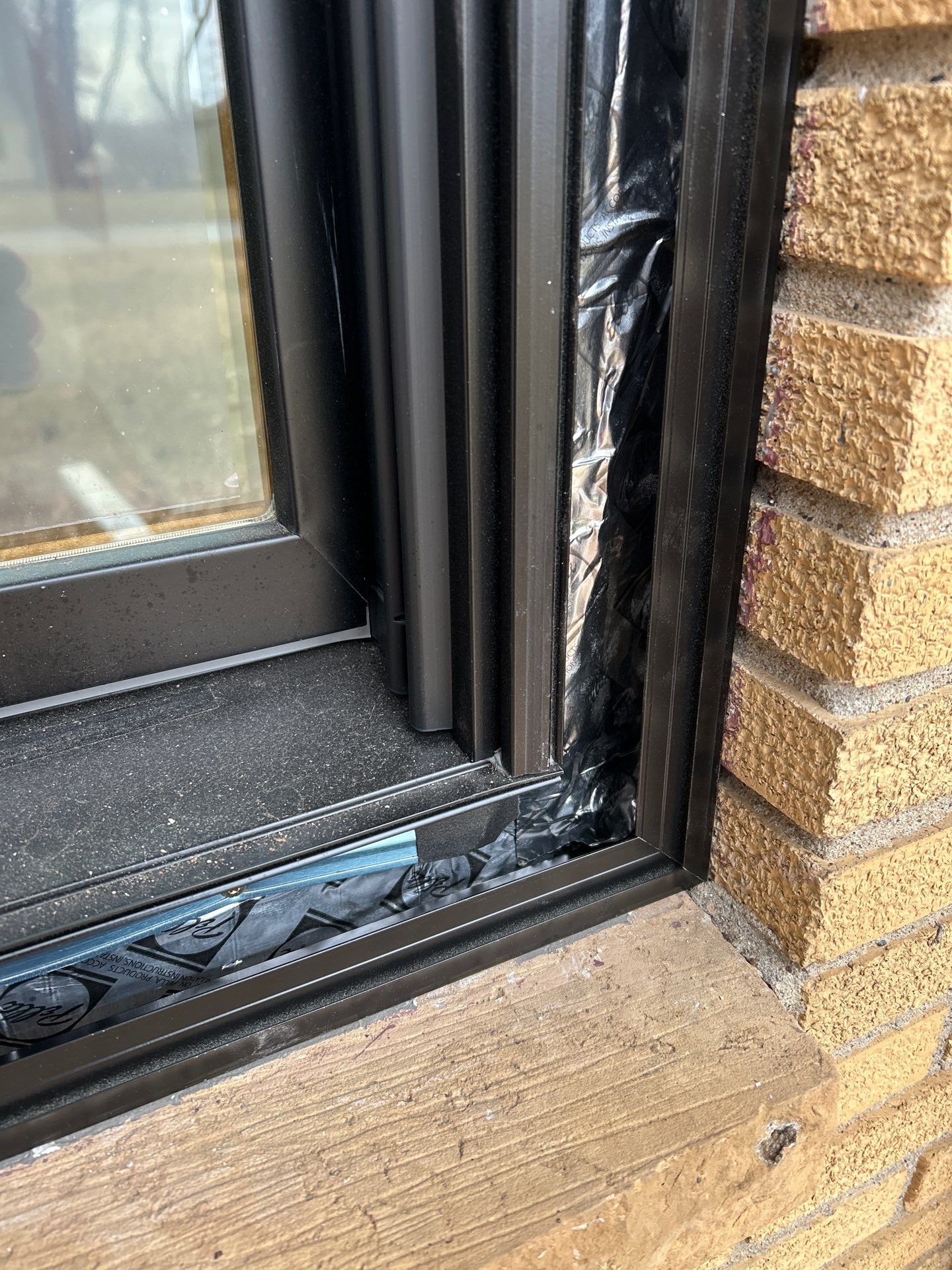 Black-Frame Pella Lifestyle Upgrade on a Partial Brick Home by United Windows and Siding LLC