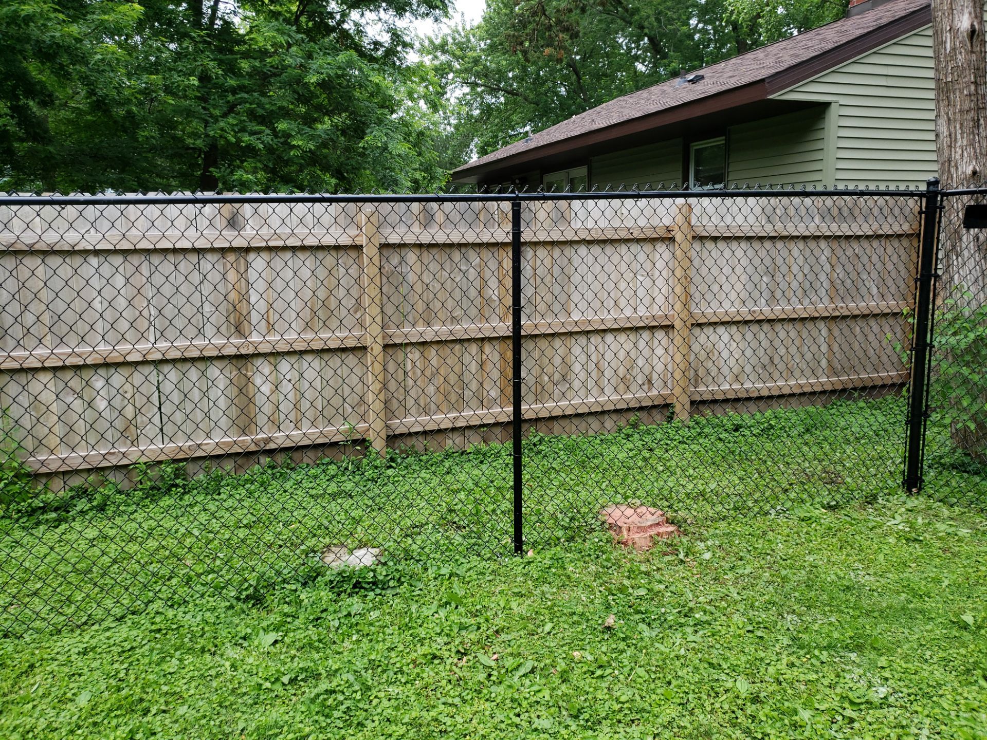 Black Vinyl Chain Link Fence Installation in Charles City by Perfect Picket Fence and Stain