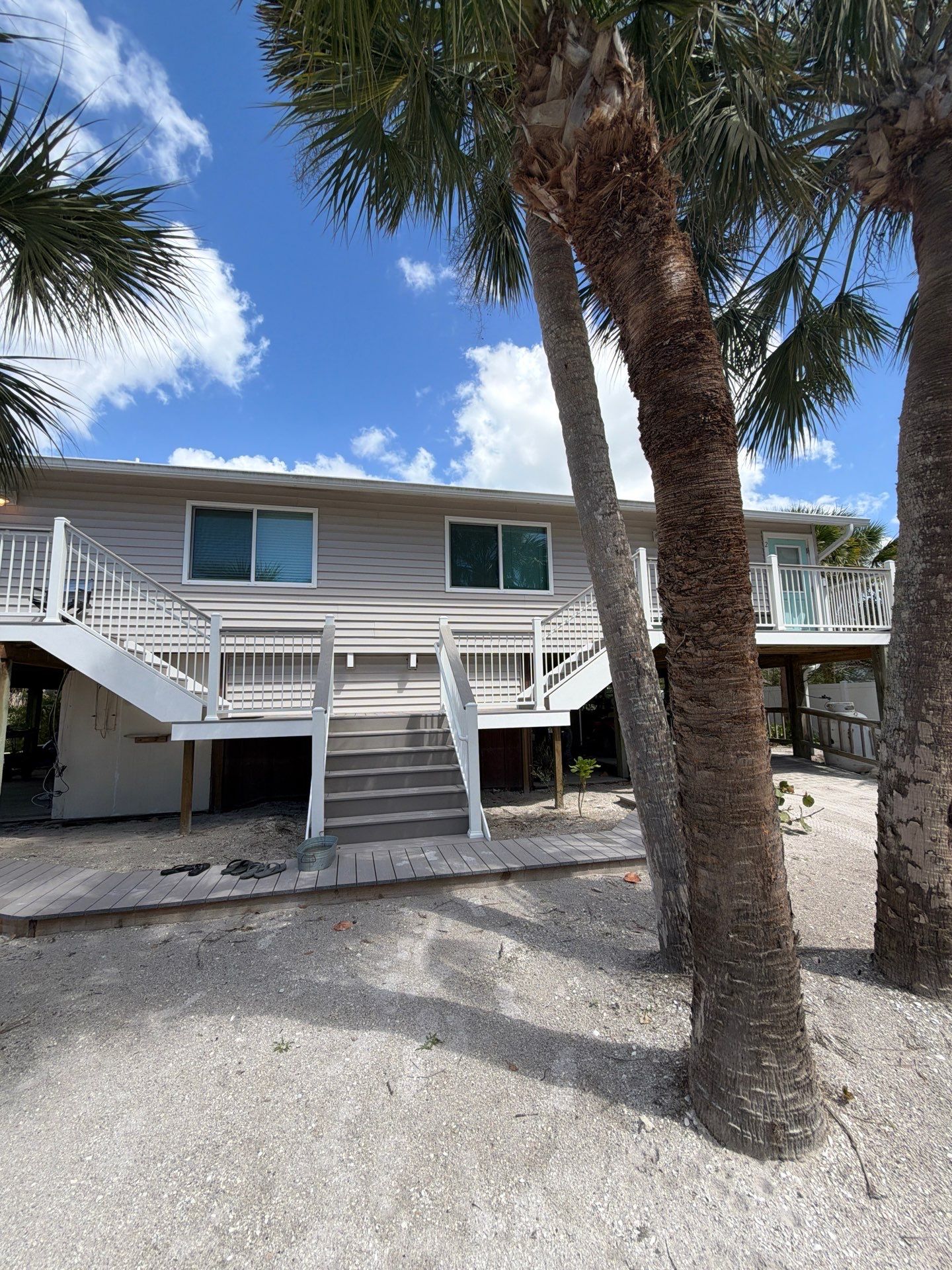 Elevated Home Deck Reconstruction With White Aluminum Railings in Placida by Smirnov Construction Inc