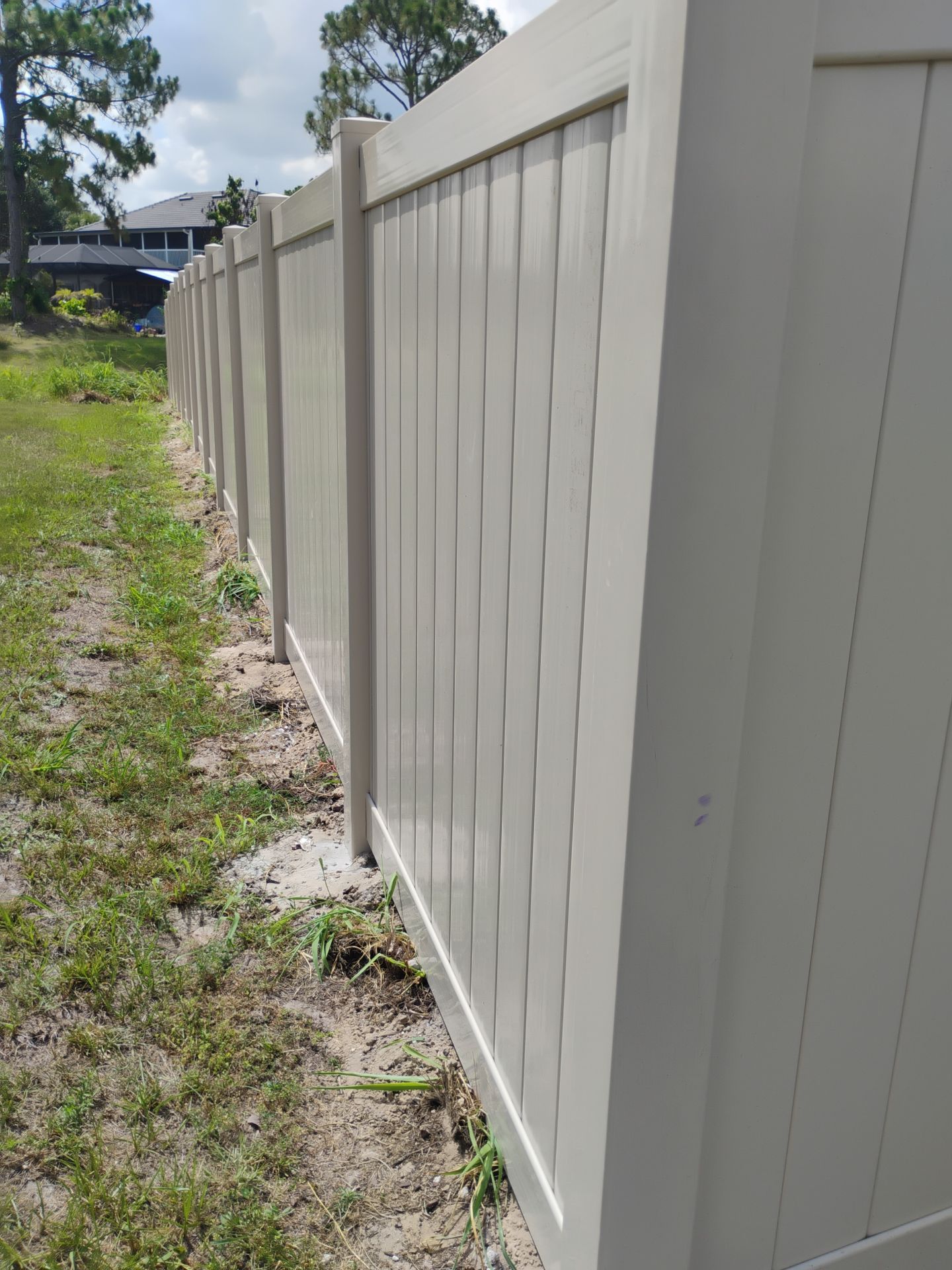 Tan Vinyl Privacy Fence and Gate Installation in North Port by True Fence LLC