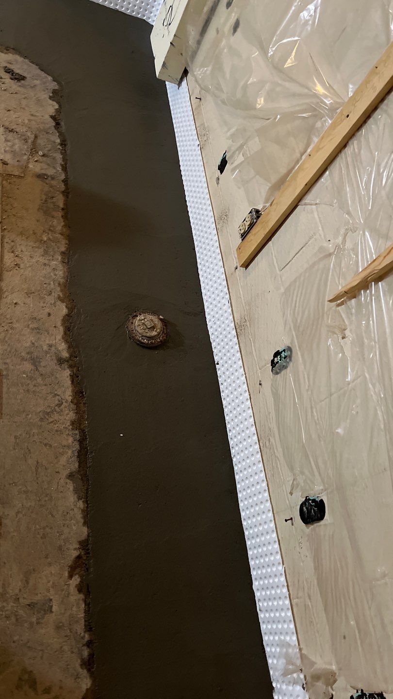 Interior drain tile system installation by ACE Waterproofing & Basement Solutions