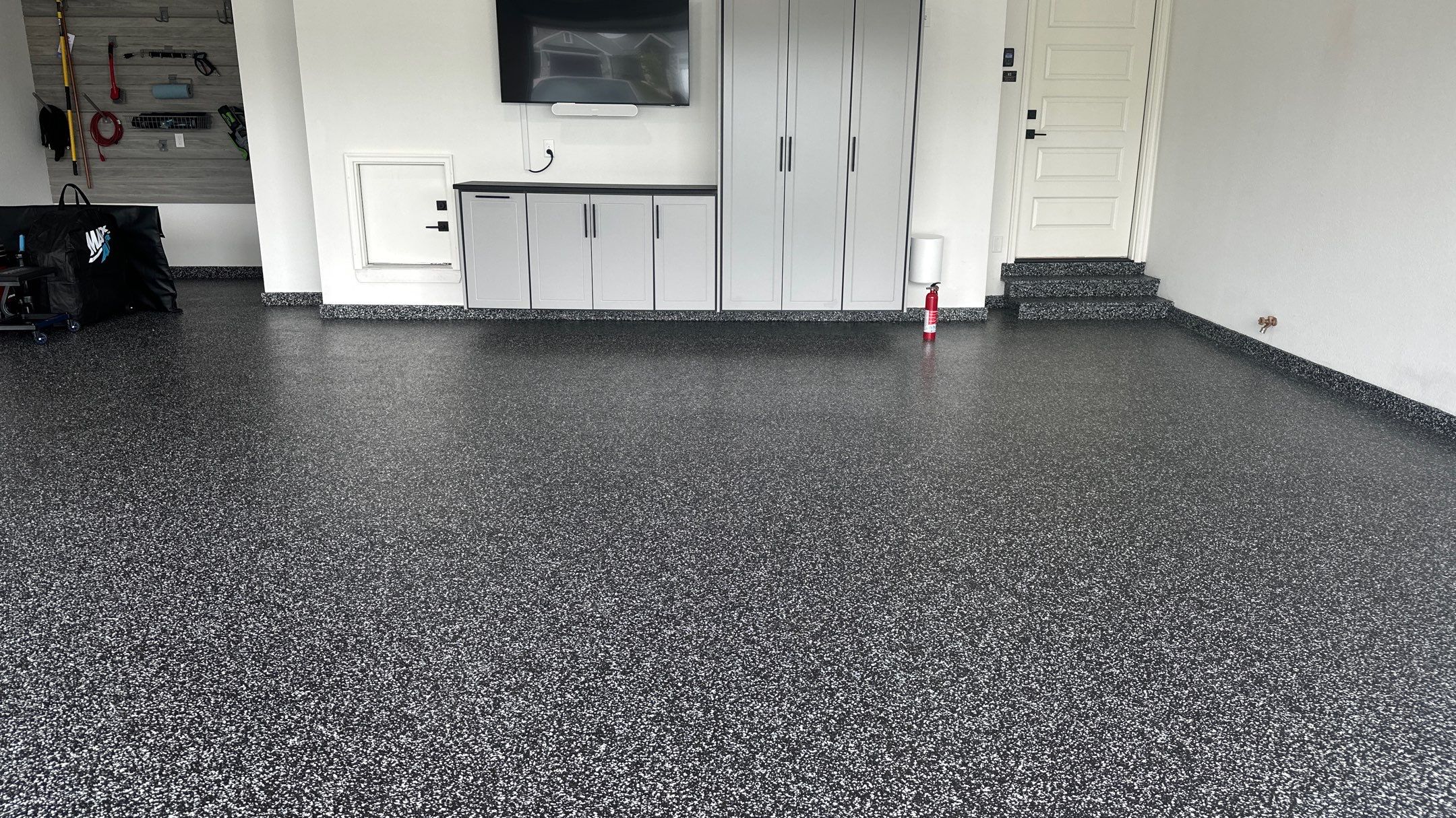 John H. received his dream garage with cabinets and a Banner Garage Floor by Banner Garage