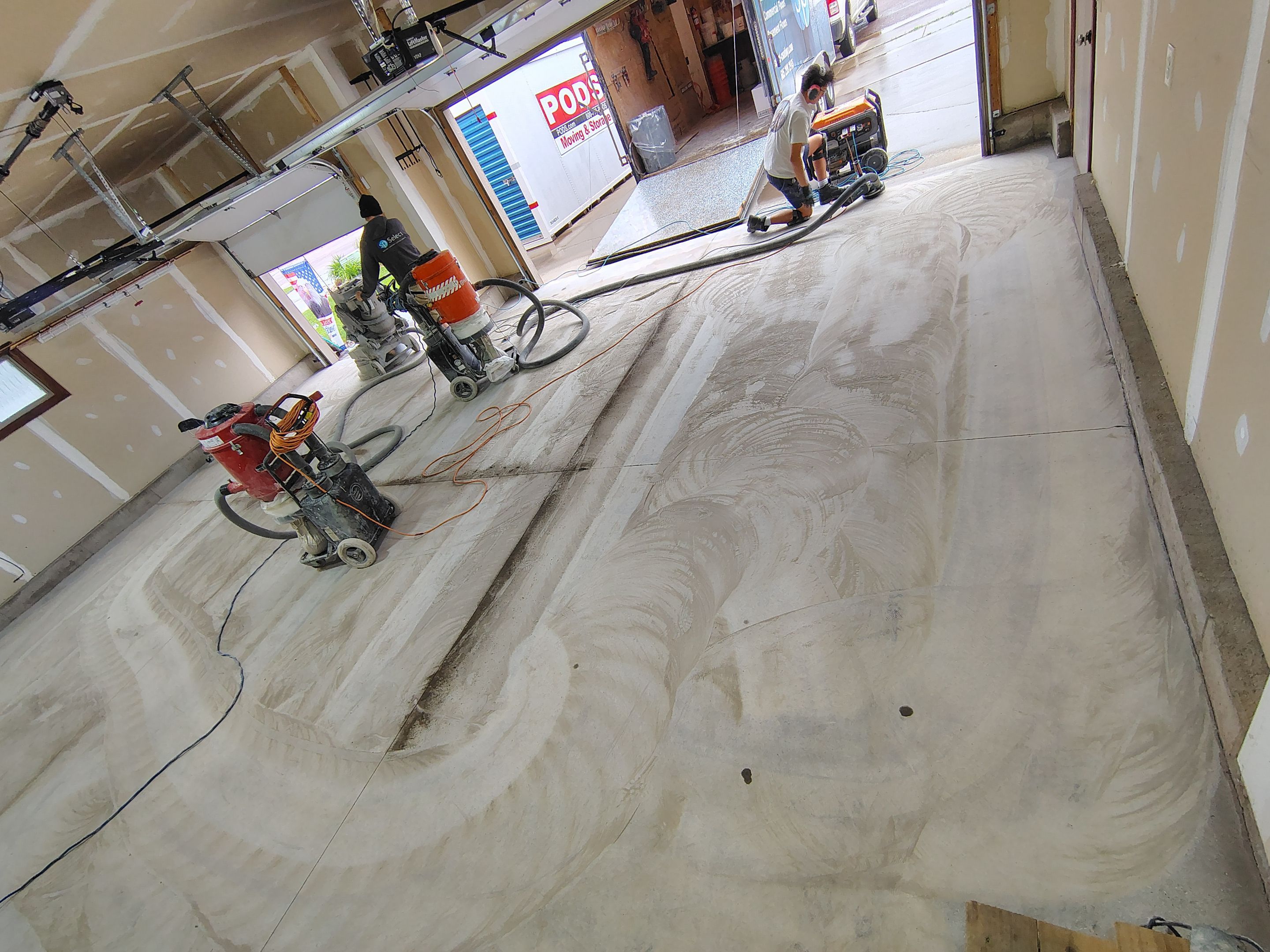Multi-Car Garage Concrete Coating and Epoxy Finish in Sioux Falls by Select Painting, Coatings & Garage Cabinets