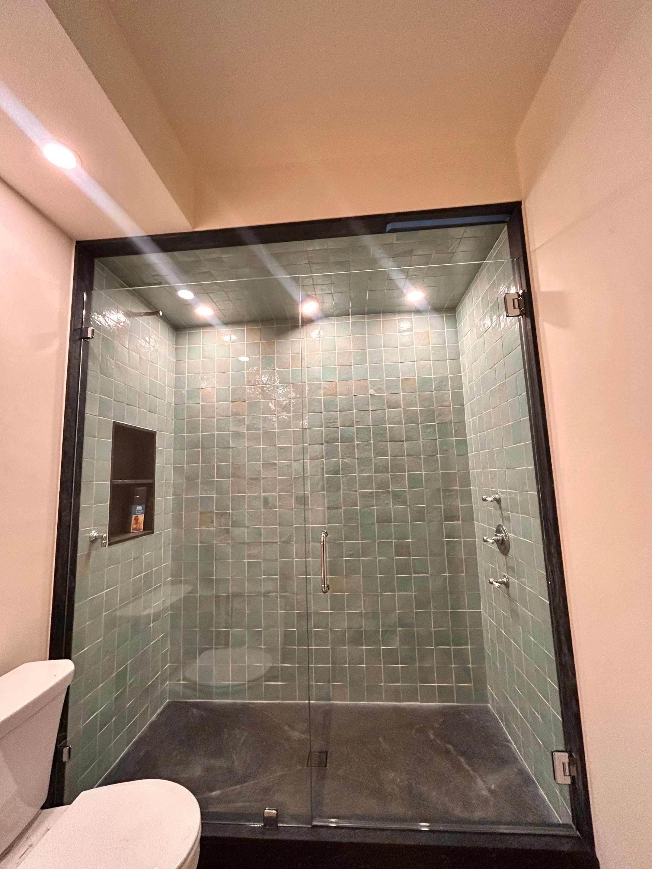 Two Showers using Tempered Shower Glass with Customer Supplied Shower Pulls by Cheshire Glass Company