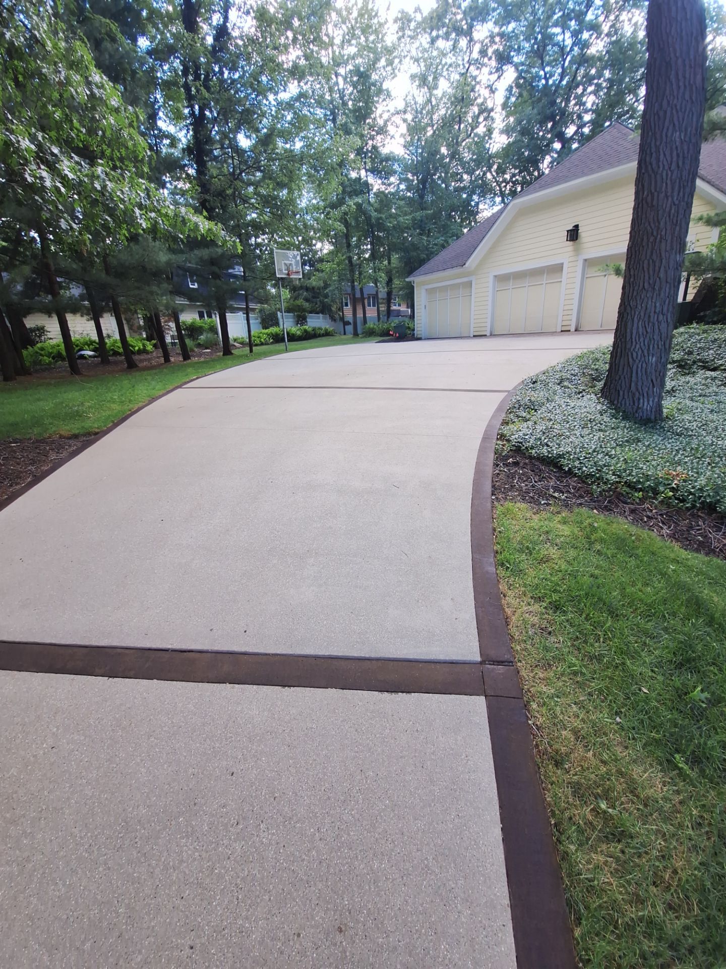 Concrete Driveway and Walkway Staining With Espresso Borders in Grand Rapids by Gordon Painting