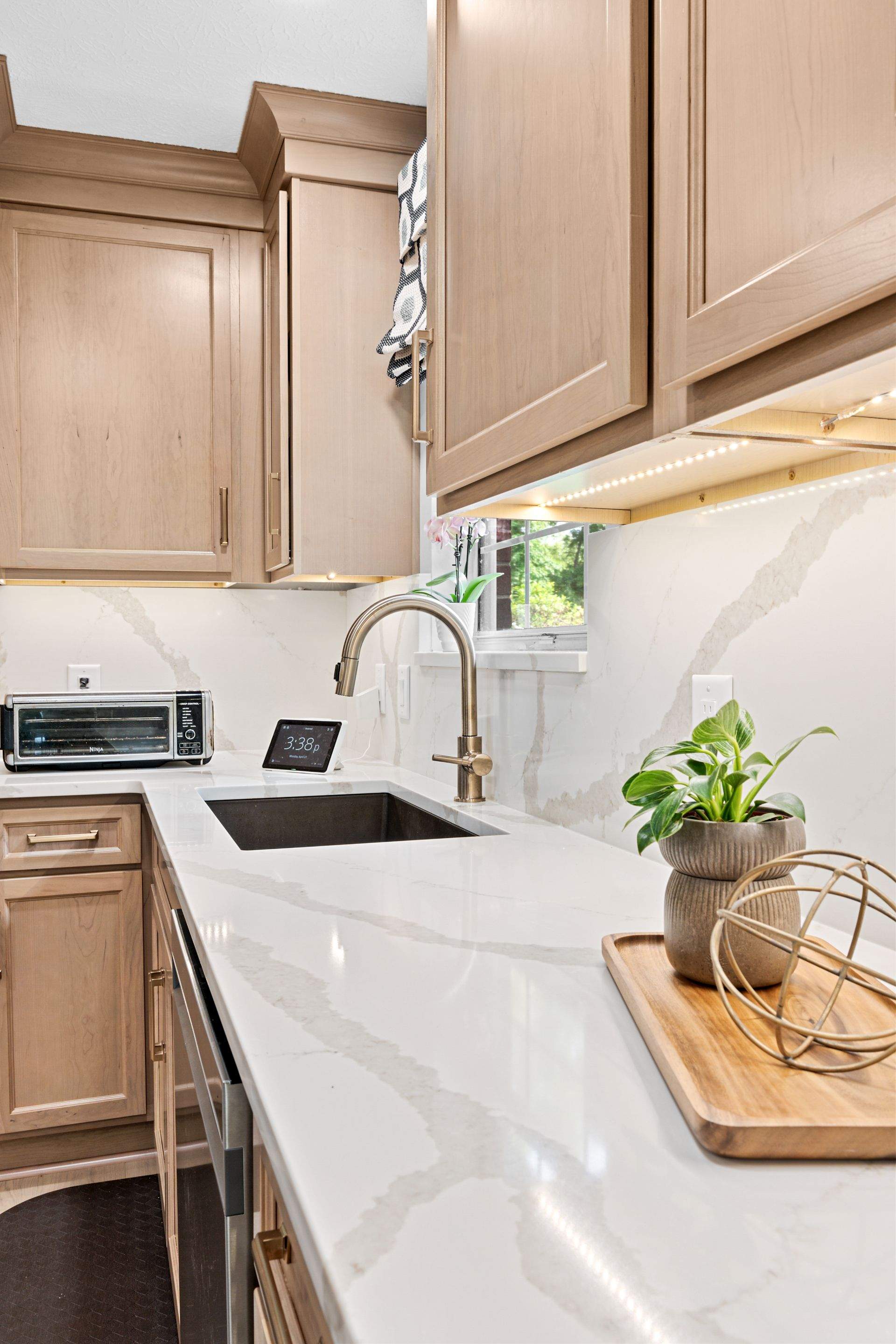 Modern Kitchen Remodel Featuring Quartz Backsplash, under cabinet lighintg, and a coffee bar in Mt. Juliet Tennessee by DeRo Renovations,LLC