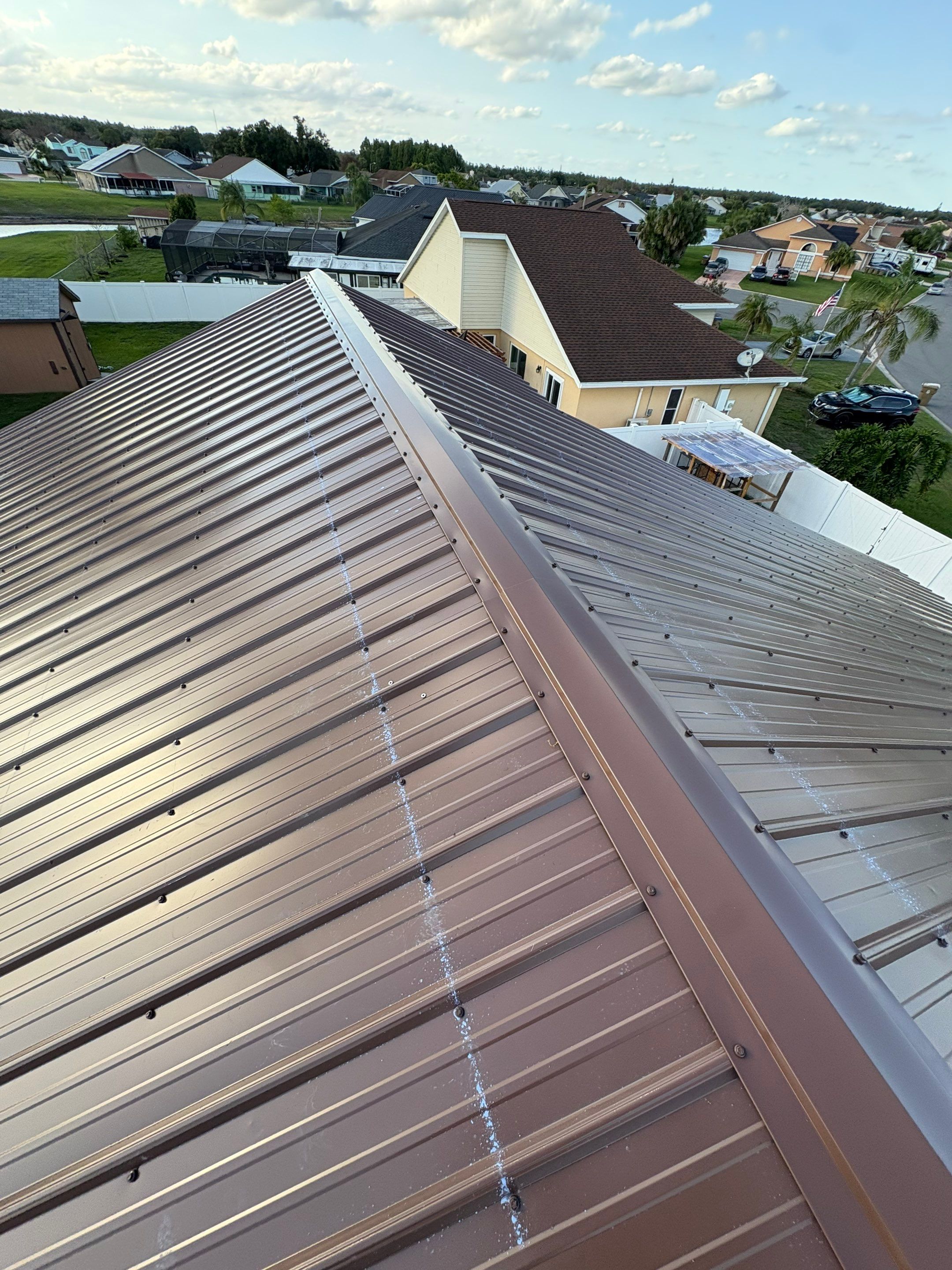 Residential Metal Roofing Installation and Gutter Replacement in Kissimmee by Pinnacle Roofing Group