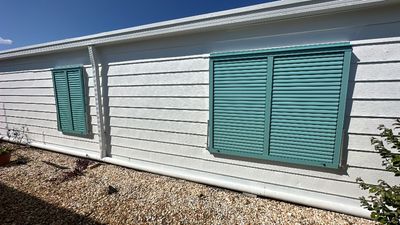 Hurricane Rated Bahama Shutters in Pastel Turquoise