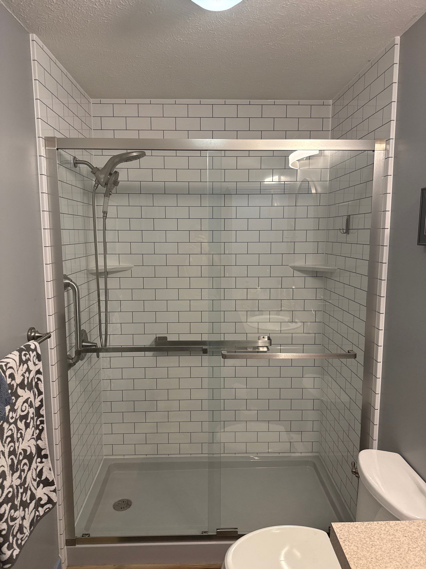 Jacuzzi Walk-In Shower Installation Featuring Subway Tile and Glass Doors by Rainbow Seamless Systems
