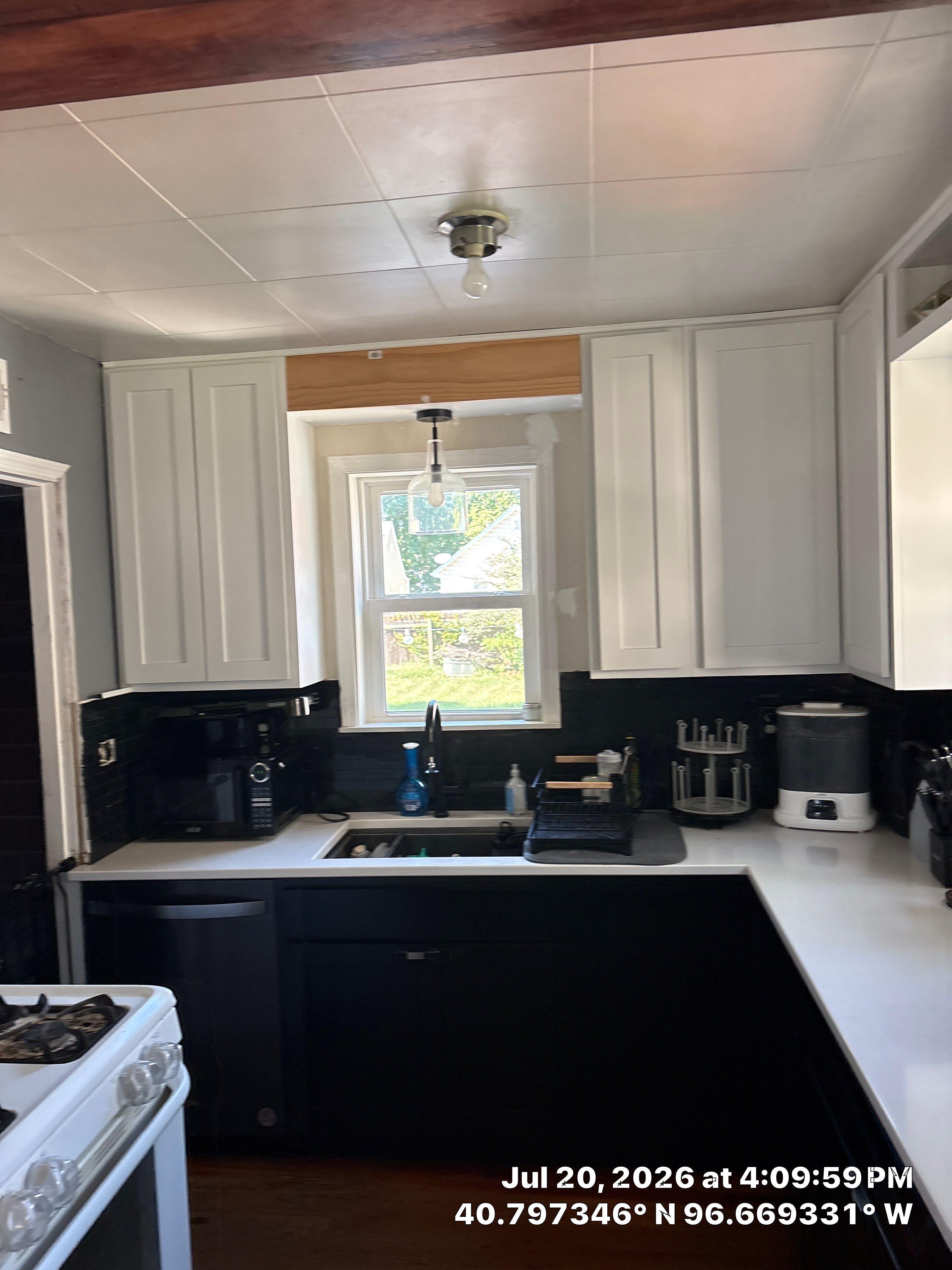 Kitchen Remodel in Lincoln Nebraska Featuring Two-Tone Cabinetry and Black Backsplash by CompanyCam Sales Demo