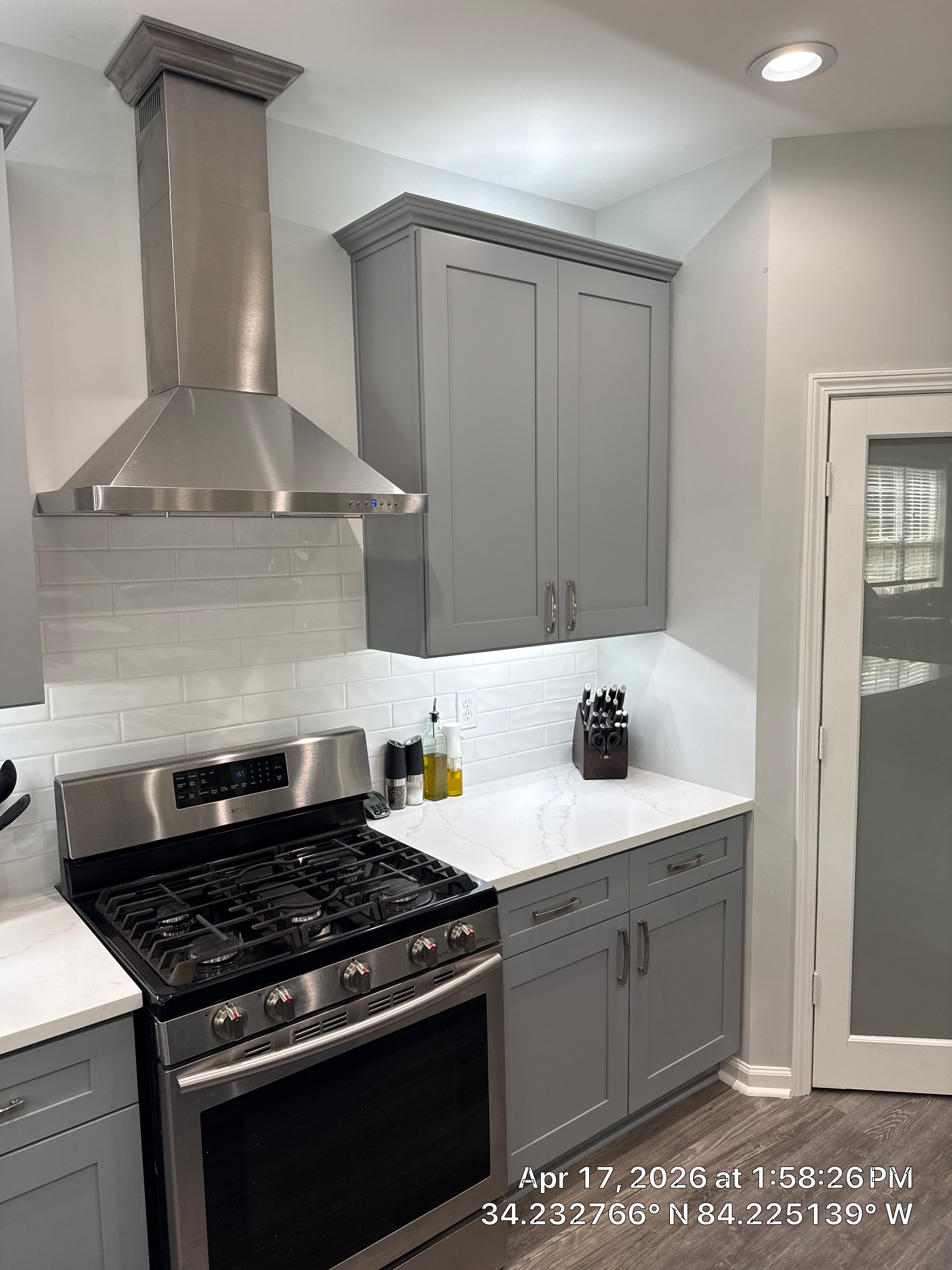 Modern Kitchen Remodel With Grey Shaker Cabinets and Navy Blue Island by Heart & Home Kitchen & Bath Remodeling LLC