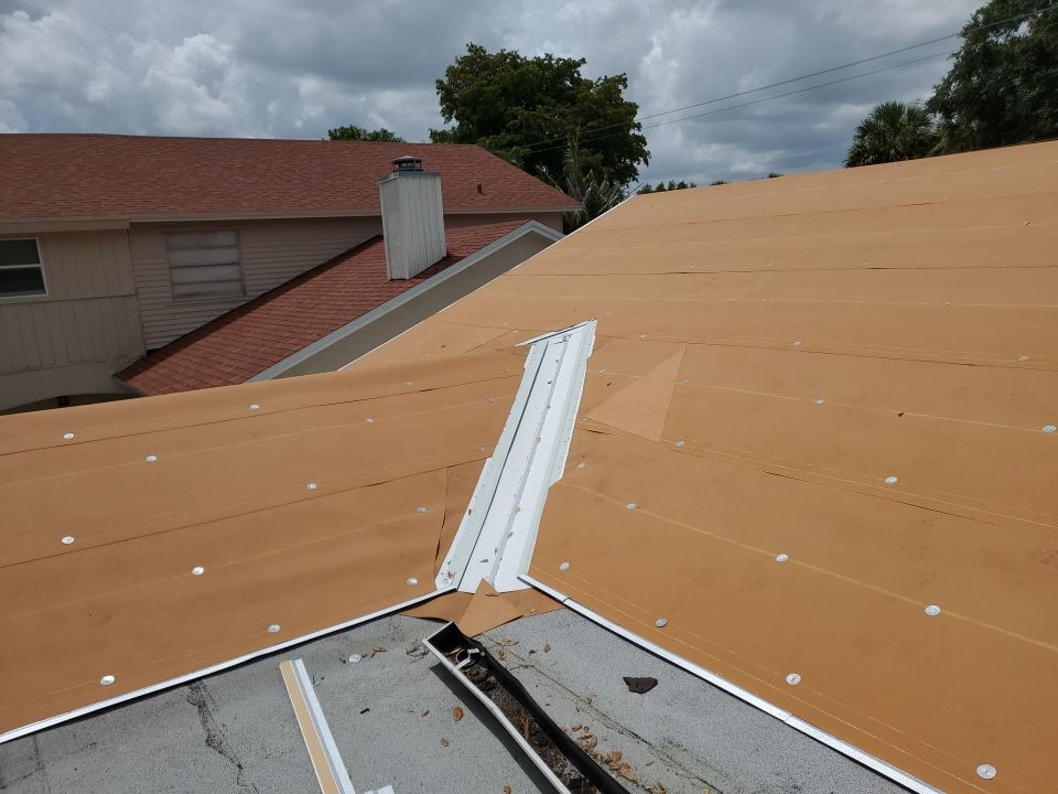 Residential Roofing Installation using 1.5" Nail Strip 24ga Solar White Kynar Coated Standing Seam Metal Panels by Morton Roofing, Inc.