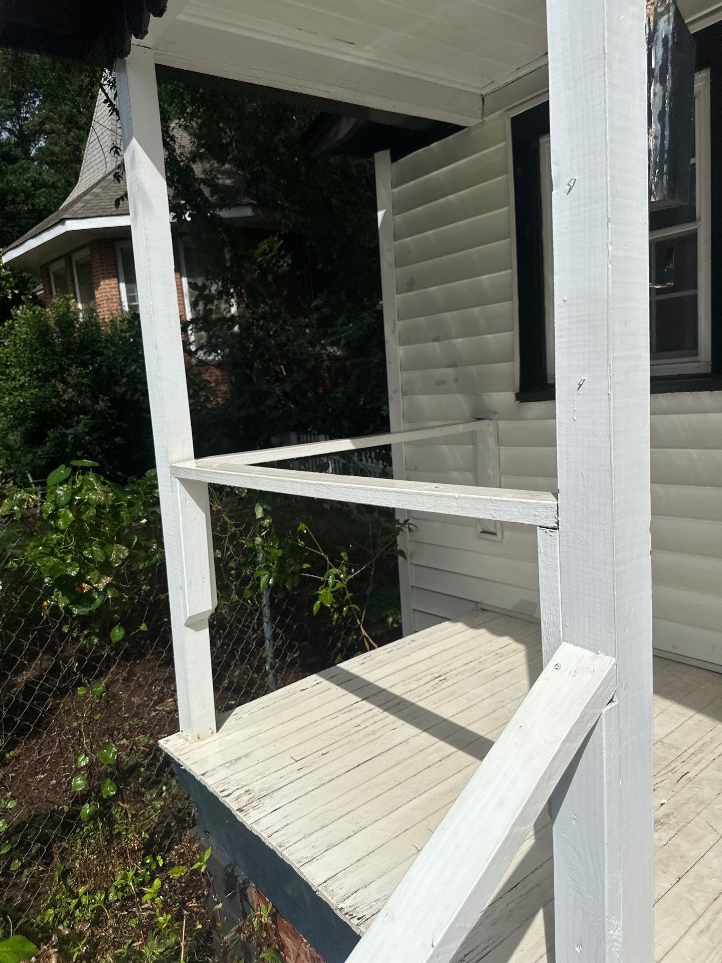 cleaning the wooden porch and railing to remove dirt and grime for enhanced appearance and maintenance