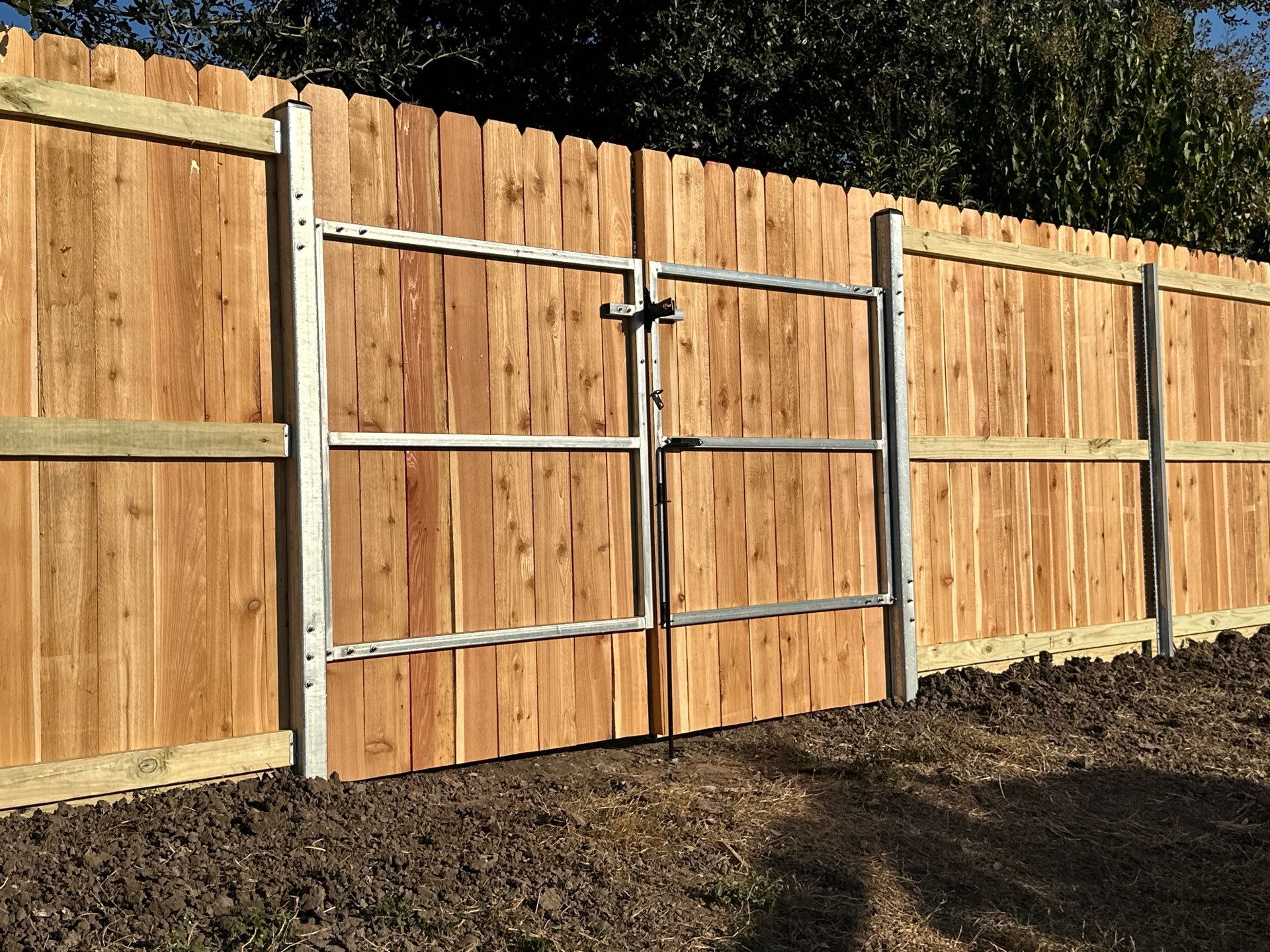 Beautiful Wood fence with metal posts by Tim's Fences