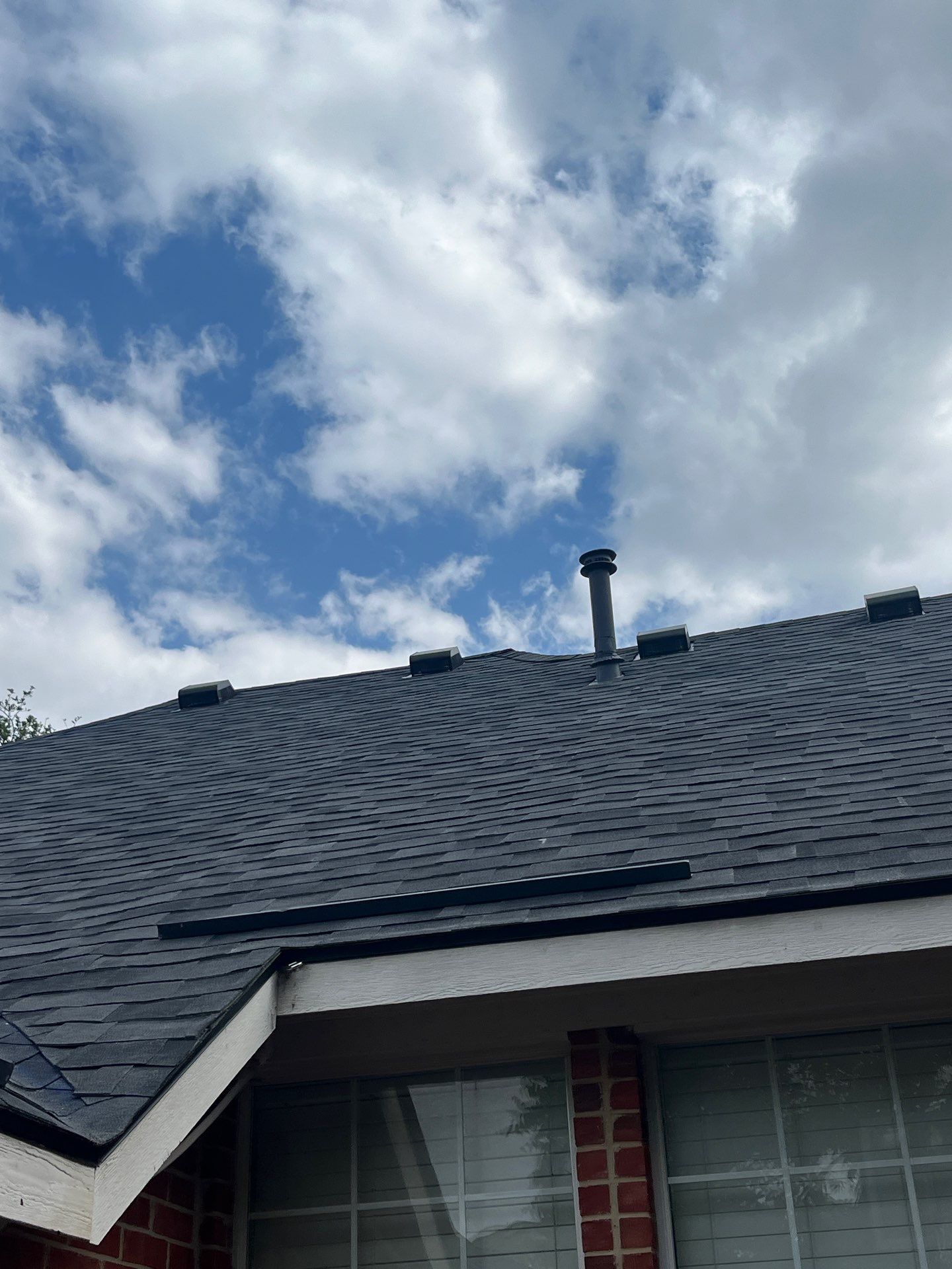 Red brick with Malarkey Midnight Black  by Tejas Roofworks + Restoration