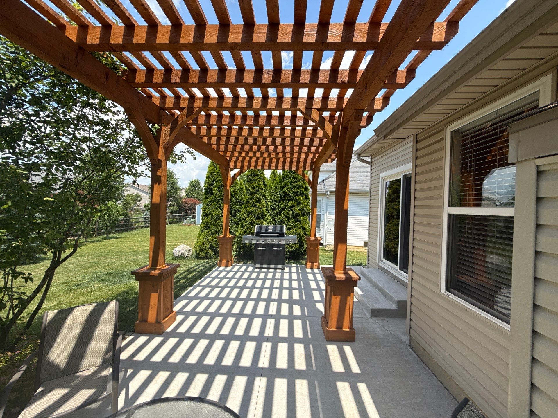 Custom Cedar Pergola and Concrete Patio Installation in Perrysburg by Farrell's Lawn & Garden Center LLC