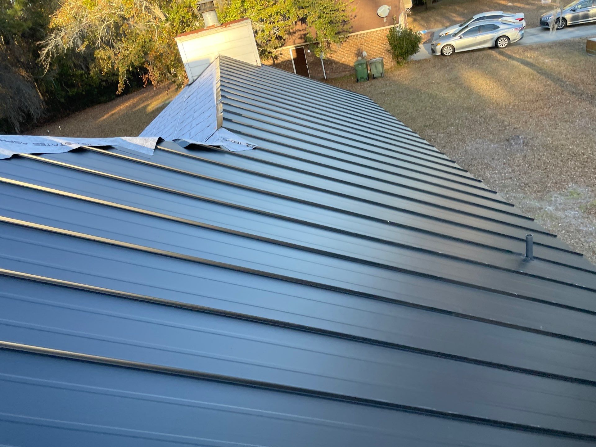 Residential Roofing Installation using Benton 26Ga 1inc Snapcock Metal Roof KYNAR Matte Black by Talya Roofing