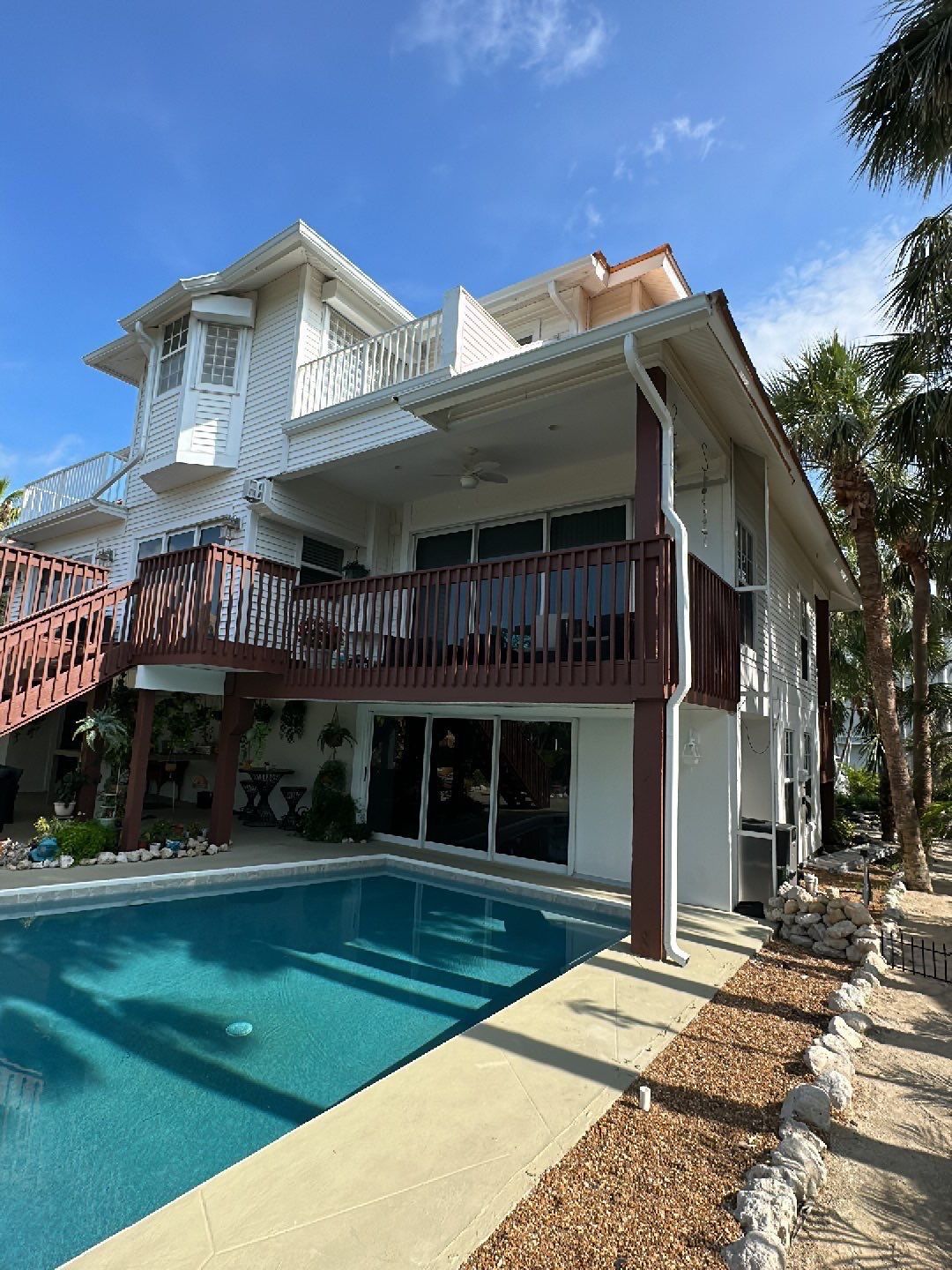 White K-Style Gutters Installed with White Downspouts in Sanibel FL by Gutter Professors