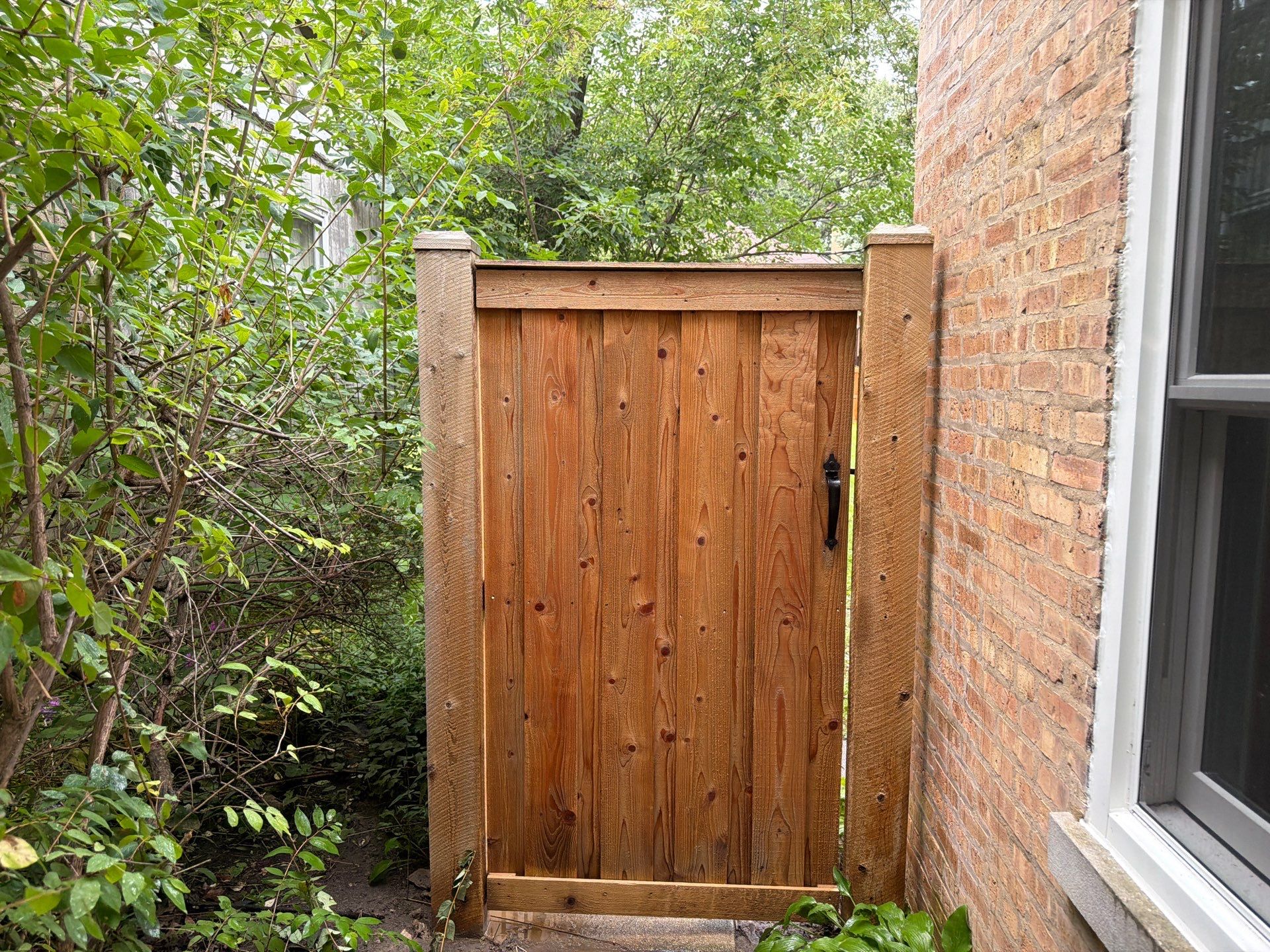 Wood fence cleaning and sealing by Northern Power Washing LLC.