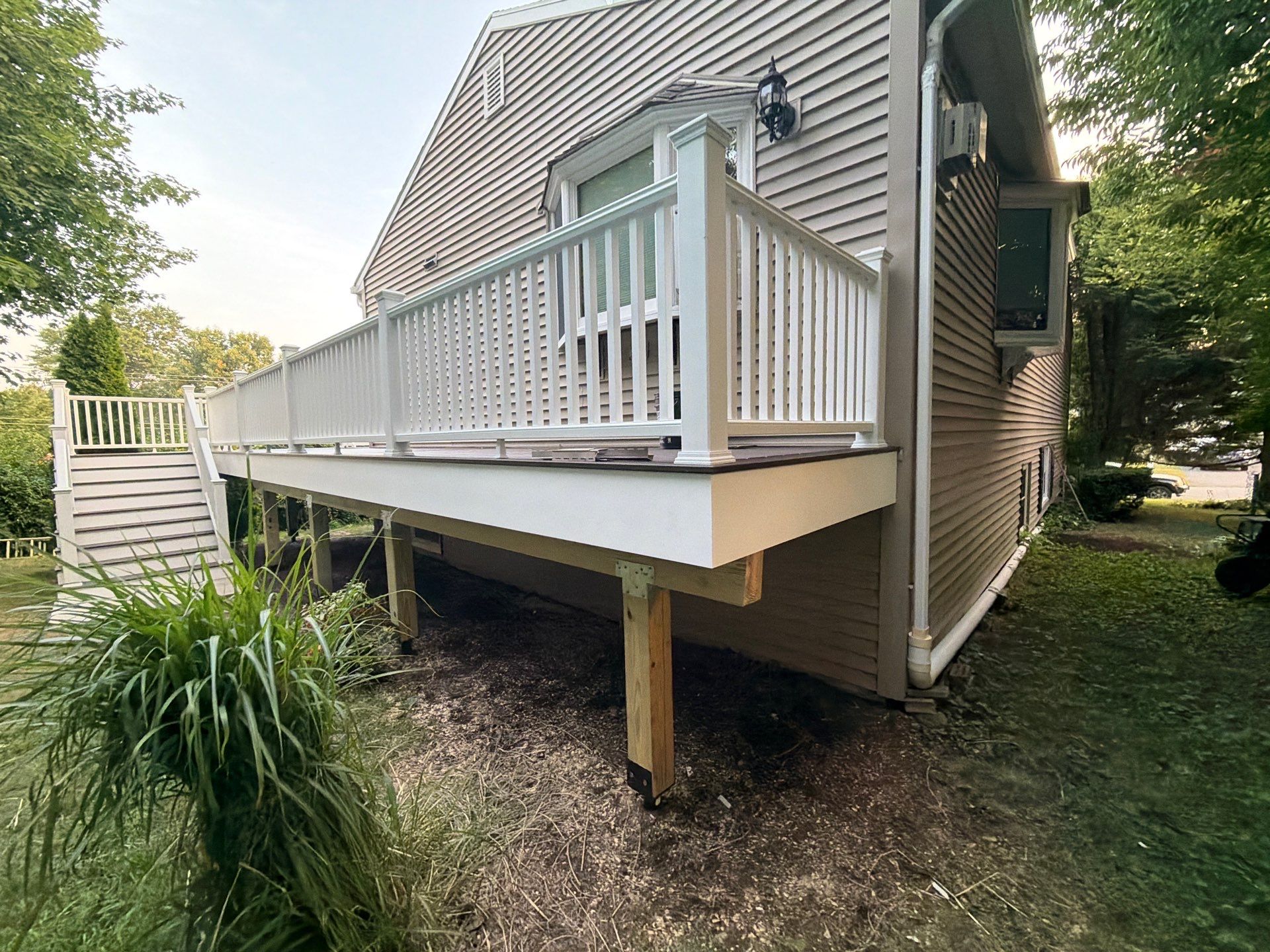 Deck Replacement using Trex Tropical Spiced Rum decking and Transcend White Railing by DiGiorgi Roofing and Siding Inc