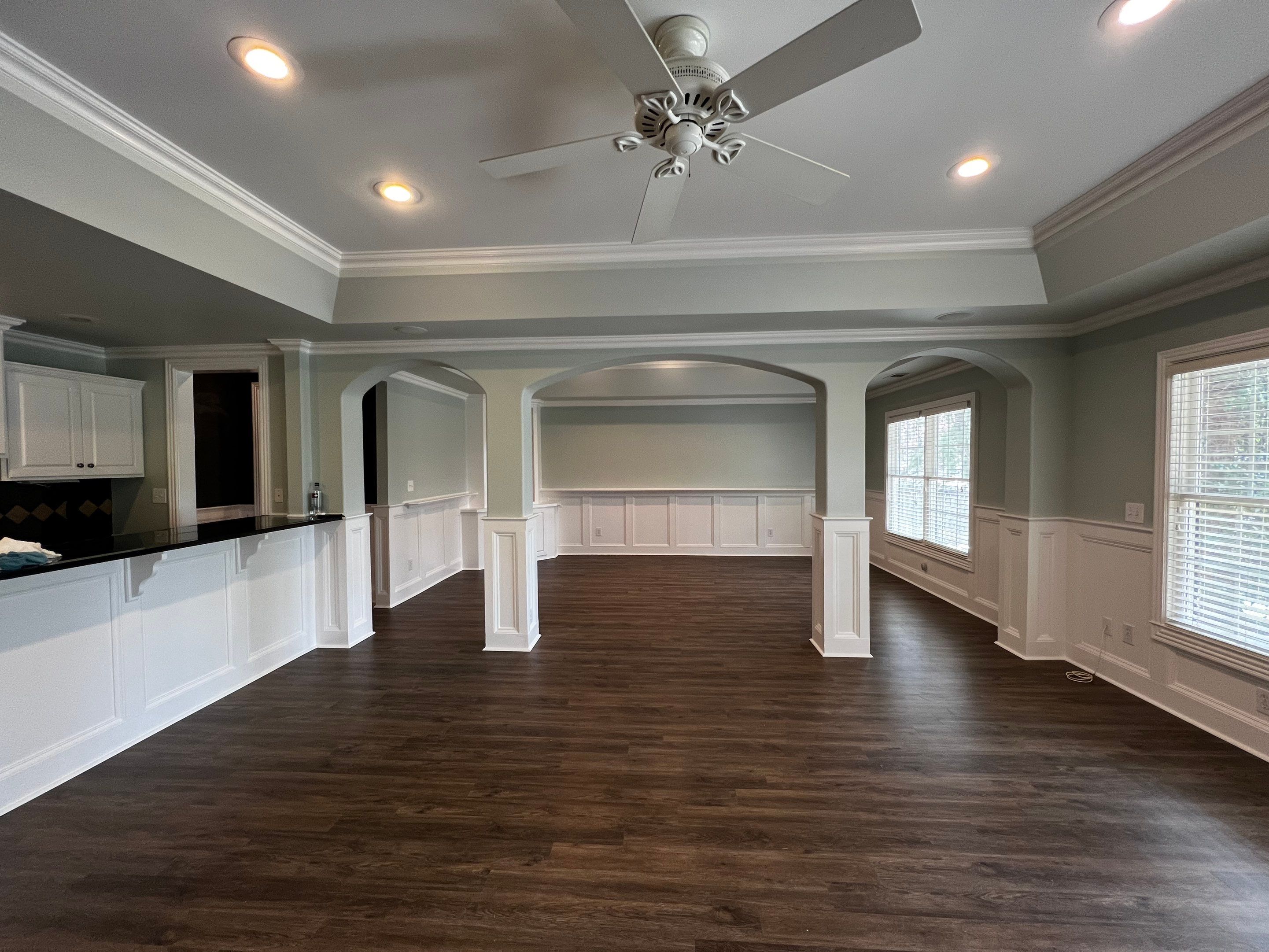 Finished Basement Remodeling with Dark Wood-Look Flooring and Custom Wainscoting by Swift Home Renovations 