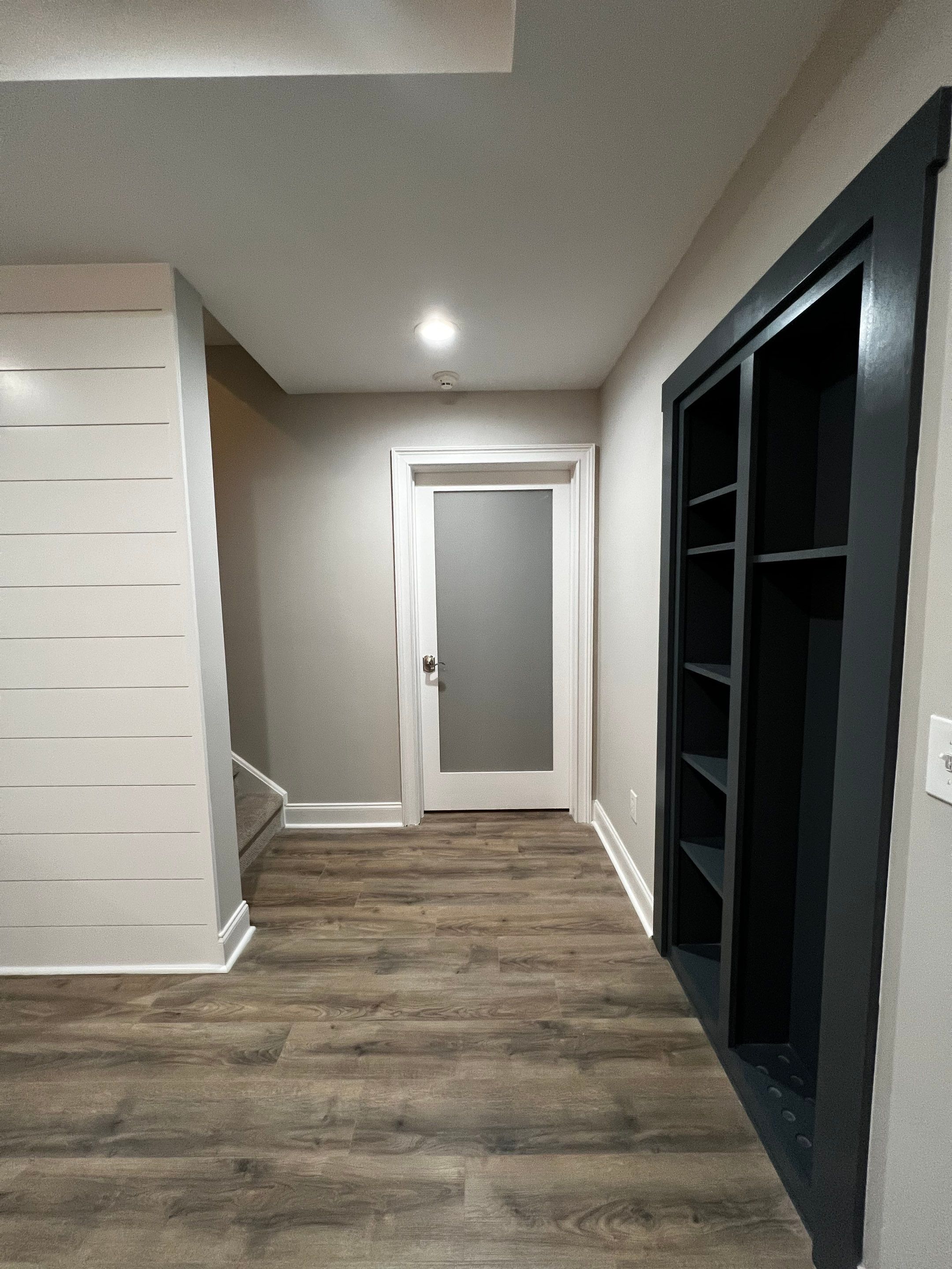 Modern Basement Remodeling in Woodstock with Custom Live-Edge Bar by Swift Home Renovations