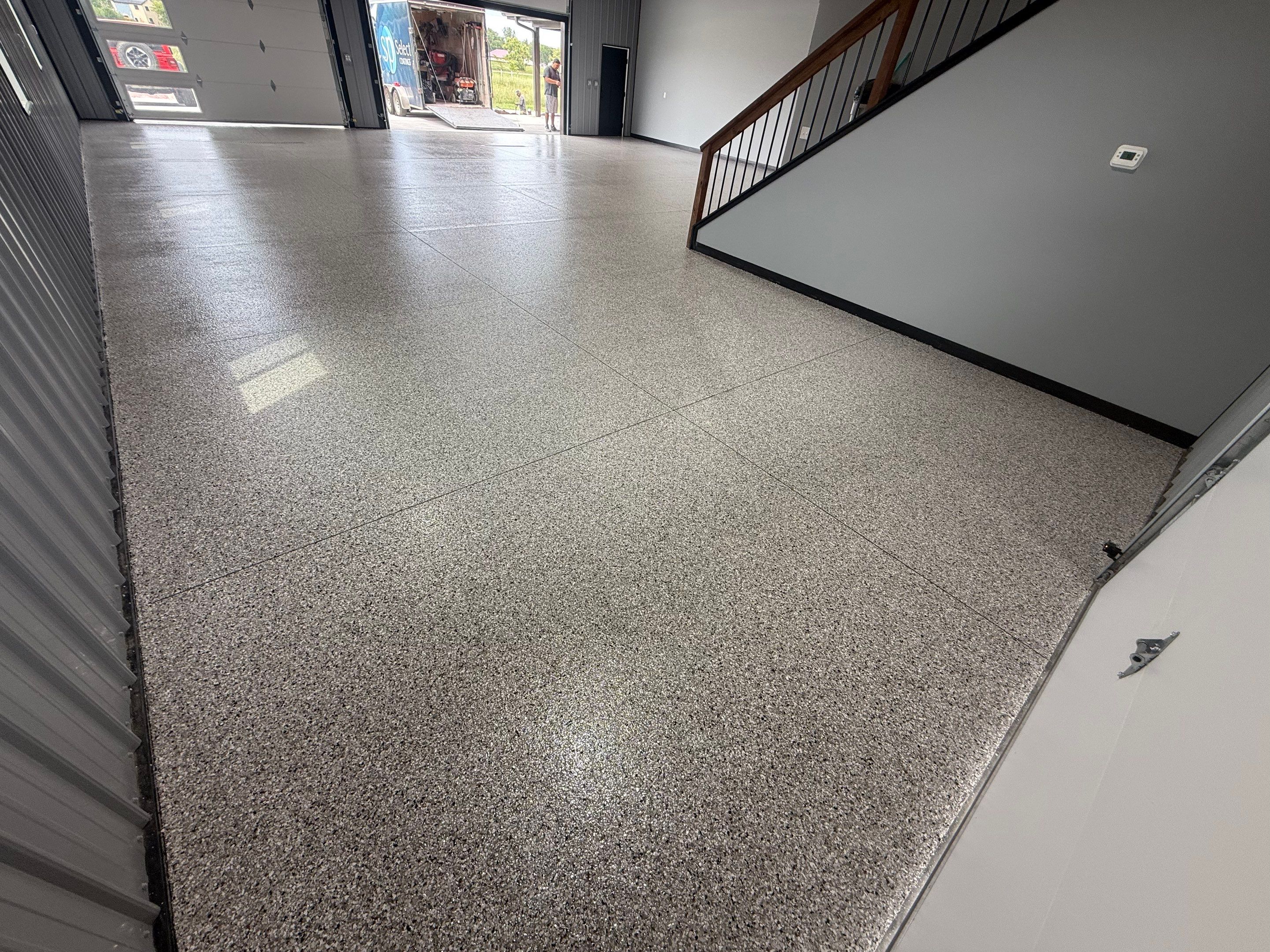 Polyaspartic Garage Floor Coating with Decorative Flake in Wentworth by Select Painting, Coatings & Garage Cabinets
