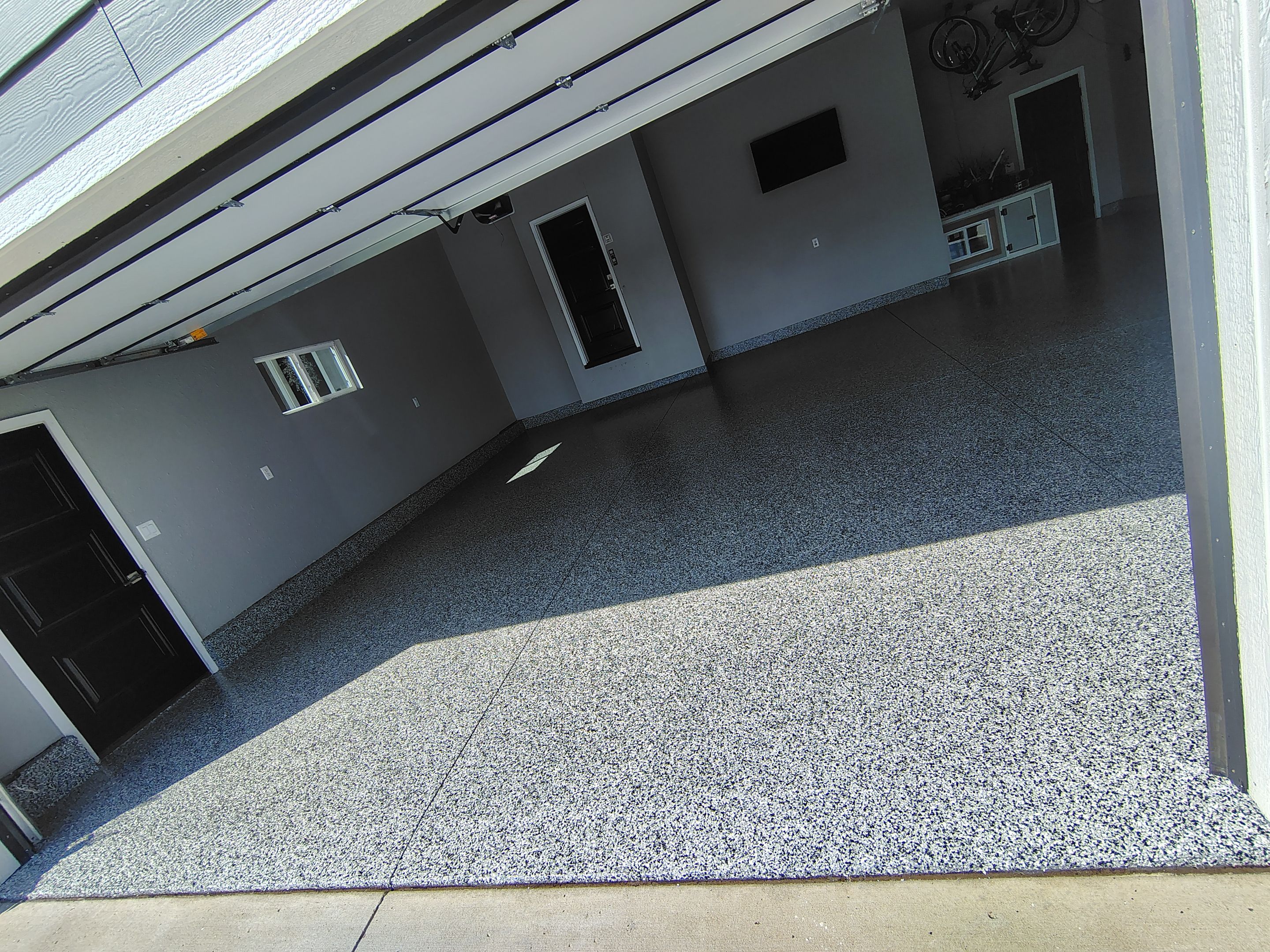 Custom Gray Flake Garage Floor Coating in Sioux Falls by Select Painting, Coatings & Garage Cabinets