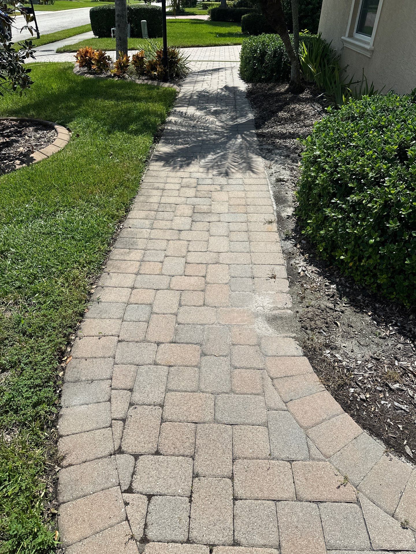 Paver Driveway, Entryway, Sidewalk, and Street Curbing Cleaning in Winding River Community, Bradenton, FL by Sunshine AquaWash