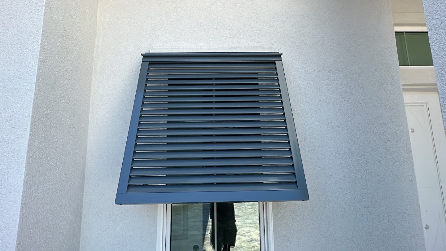 Bahama Shutters in Blue Grey  by Smart Guard Shutters