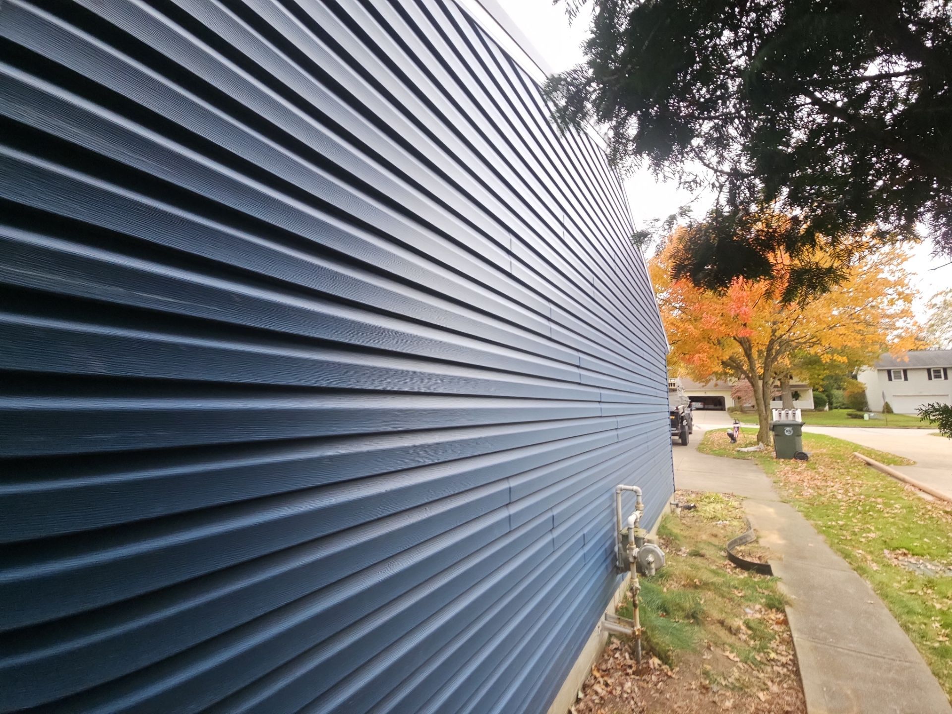 Wadsworth Exterior Transformation Featuring Blue Vertical Siding and Metal Roofing by Cornerstone Roofing And Siding