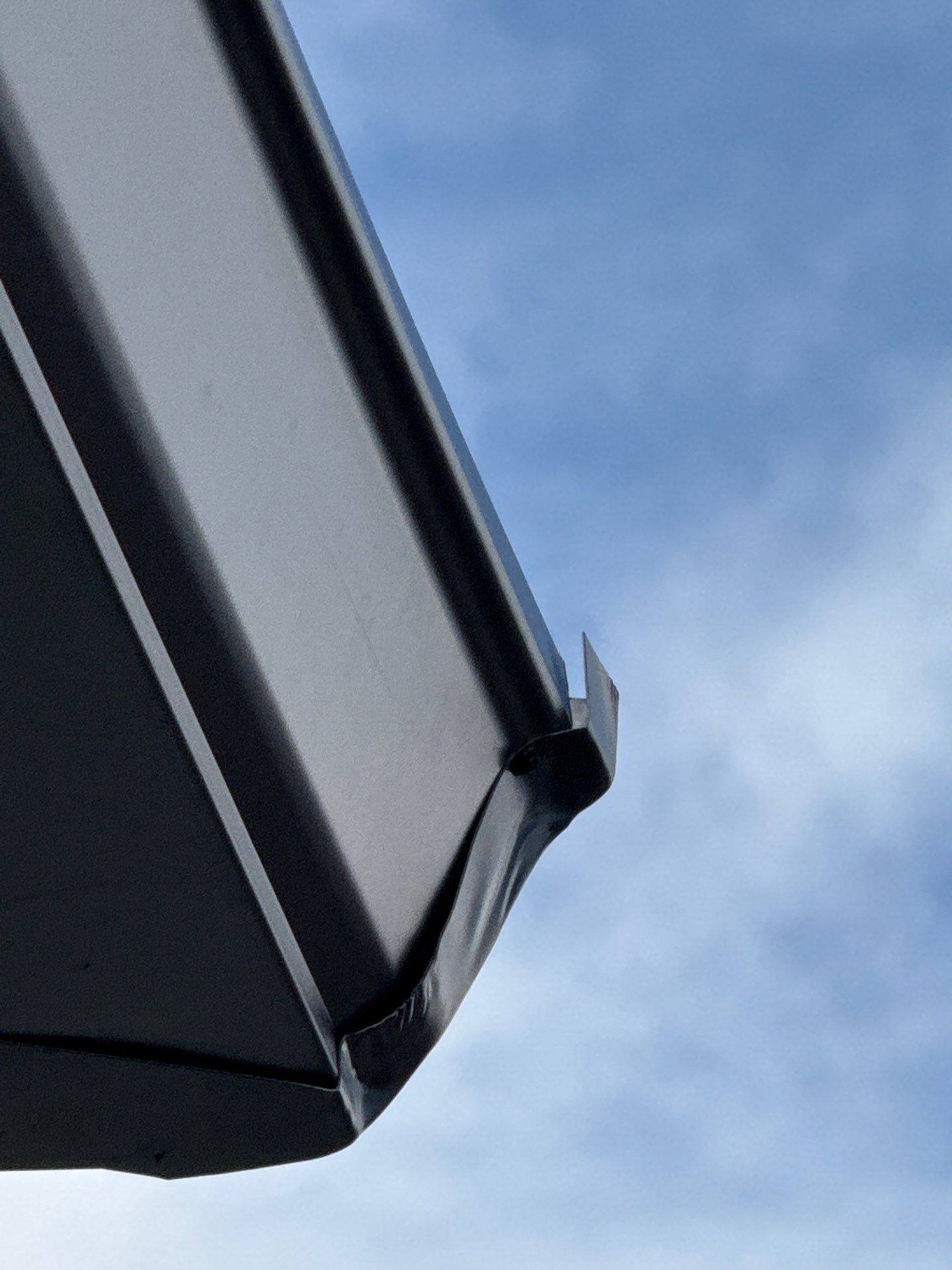 Seamless Aluminum Gutter Installation using black seamless gutters in Sarasota FL by Gutter Professors