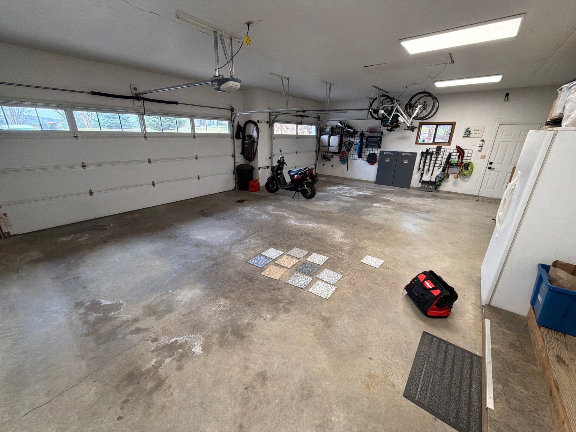 Feather Grey Garage Floor Coating Installation in Sioux Falls by Select Painting, Coatings & Garage Cabinets