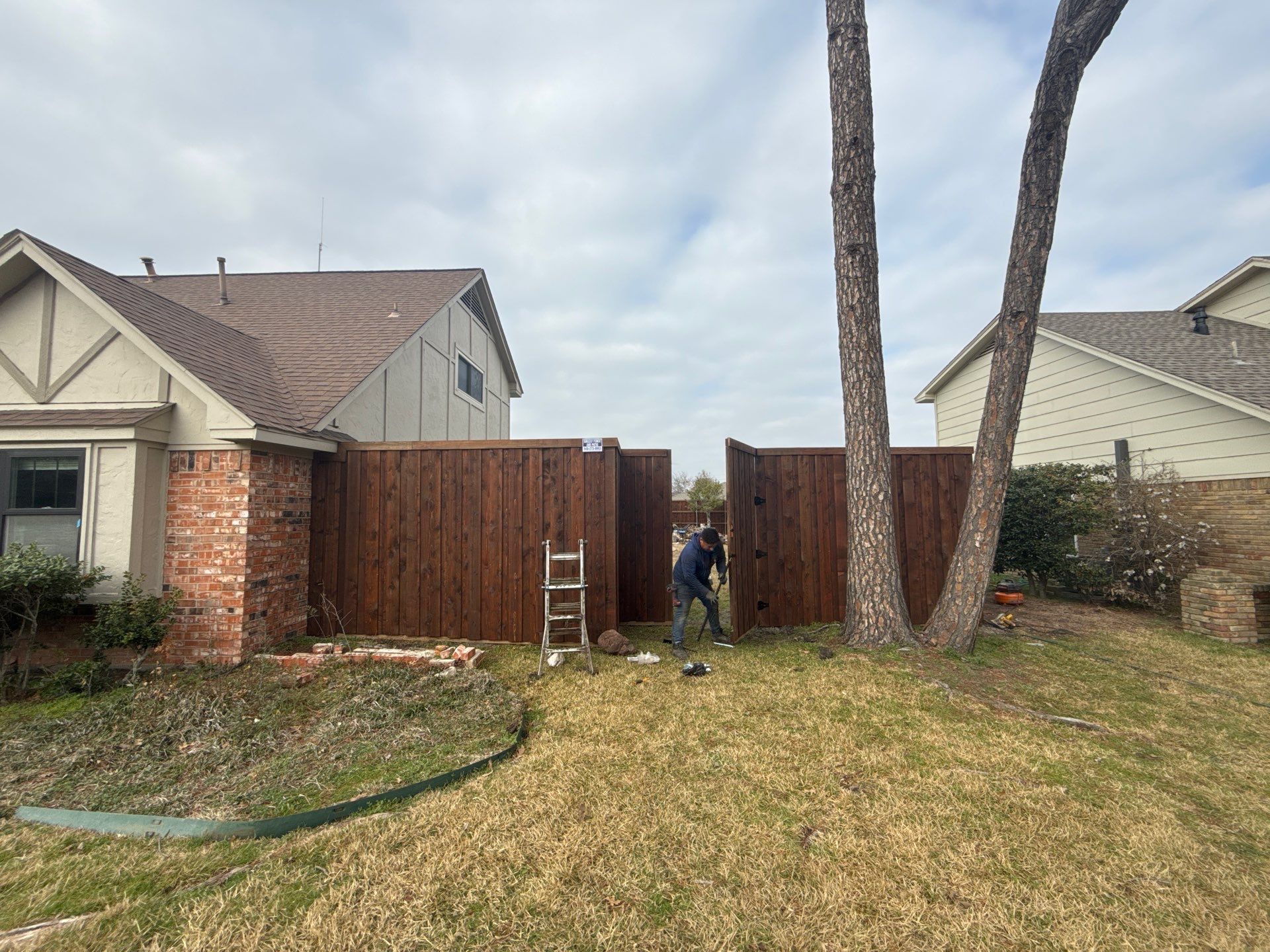 Pre-Stained board on board w/ trim and kickboard using 1x4 cedar trim by Grizzly Fence And Patio