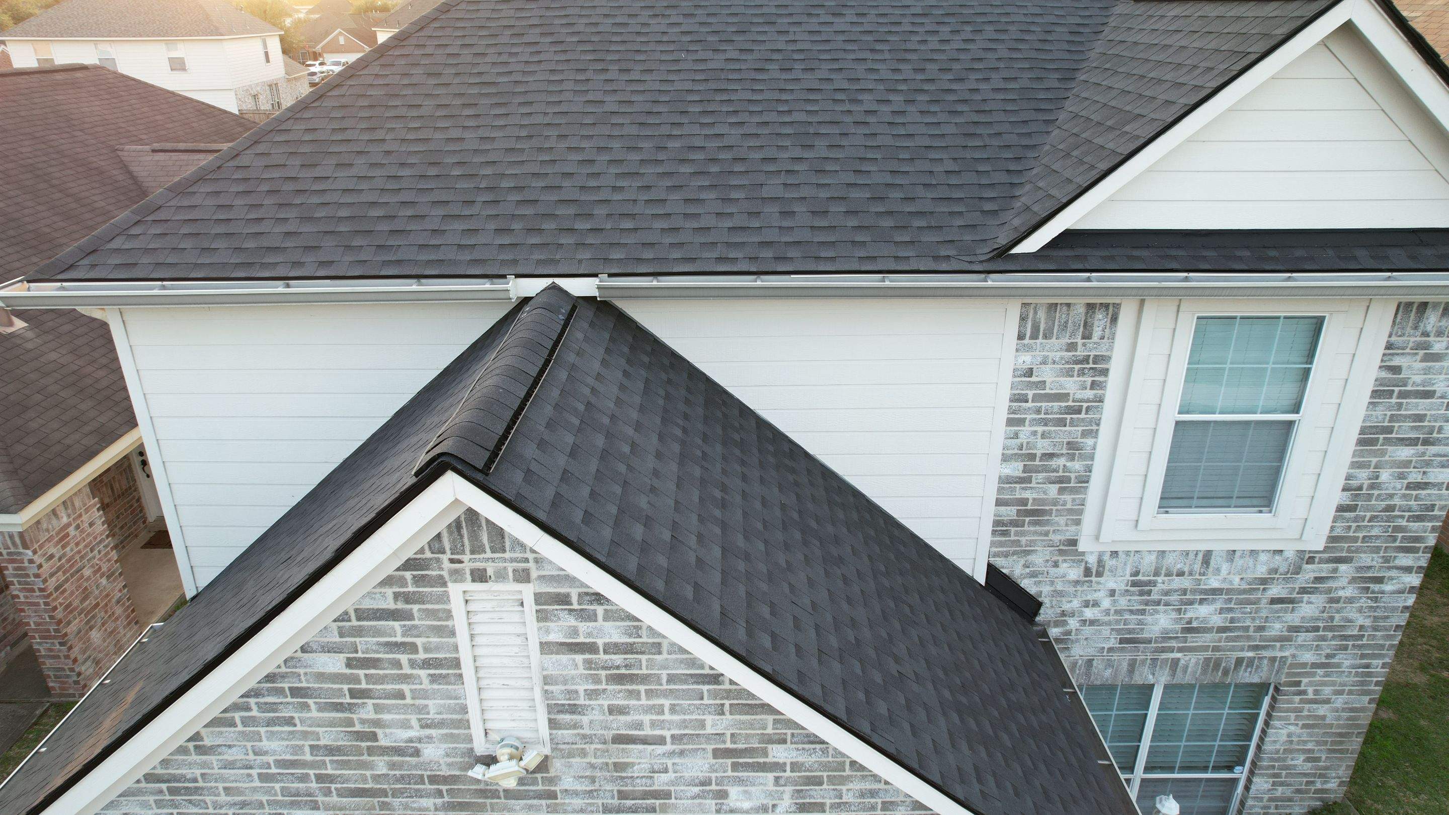 Slate-Gray Roof on Stone-Front Home — Spring, TX by PL Roofing & SB Roofing, LLC.