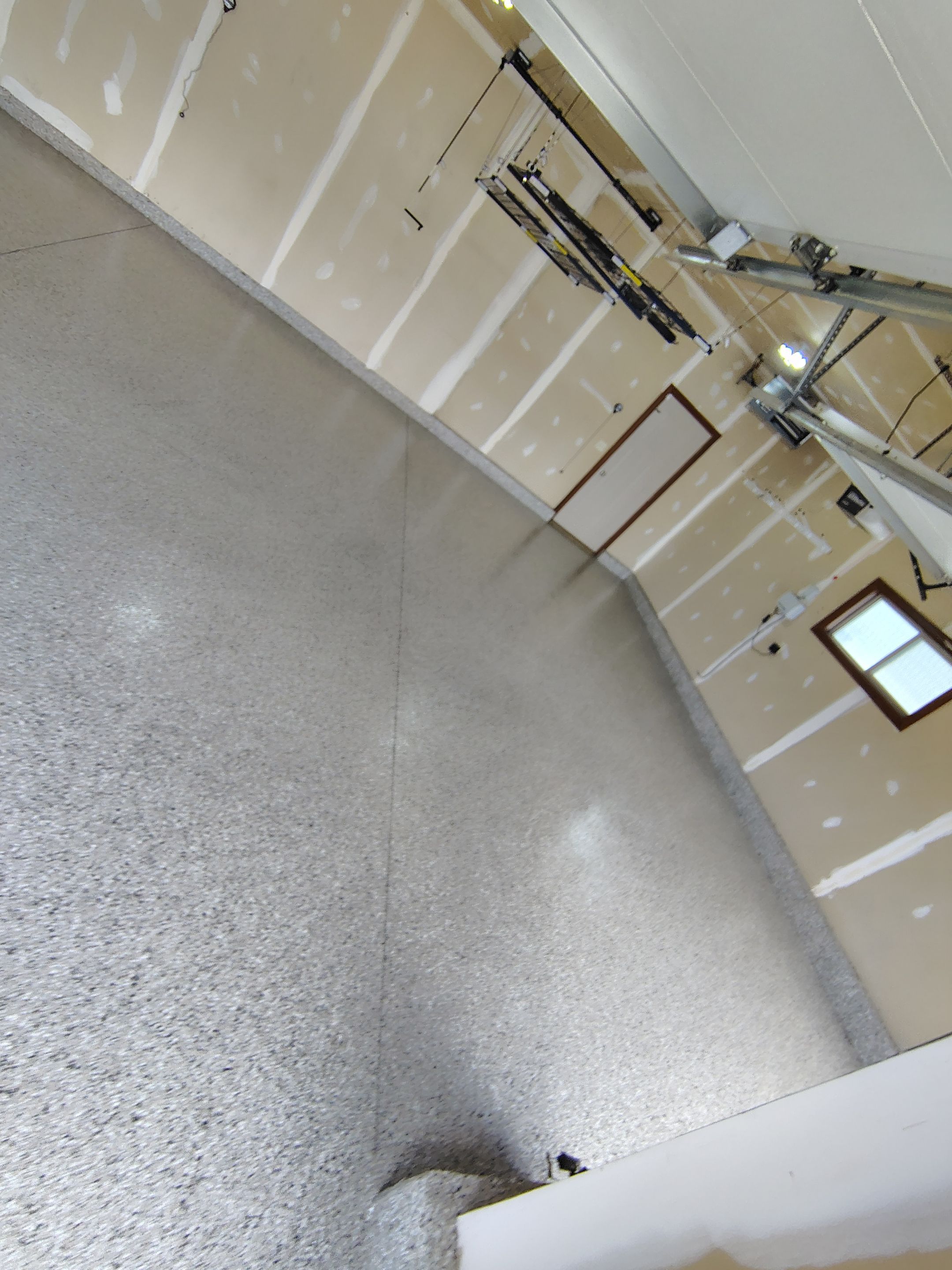 Multi-Car Garage Concrete Coating and Epoxy Finish in Sioux Falls by Select Painting, Coatings & Garage Cabinets