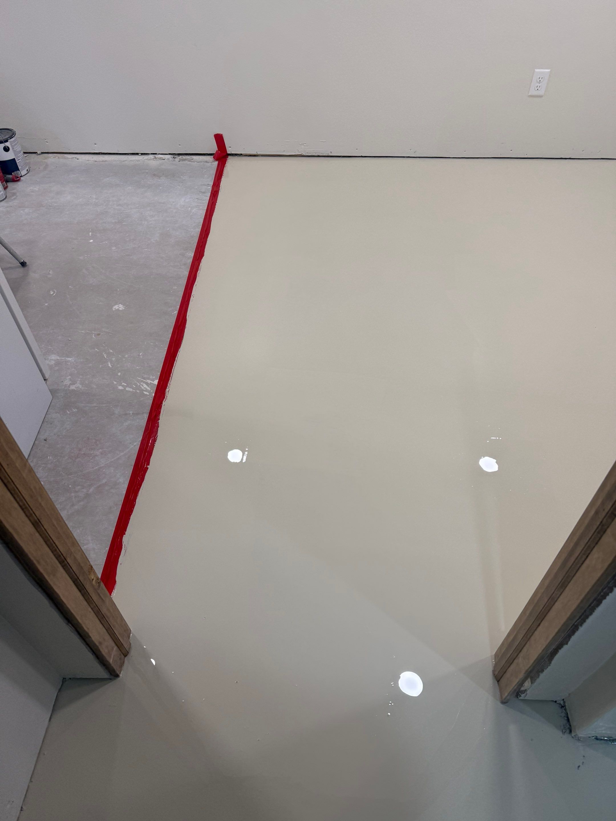 High-Gloss Epoxy Floor Coating and Basement Renovation in Rock Rapids by Select Painting, Coatings & Garage Cabinets